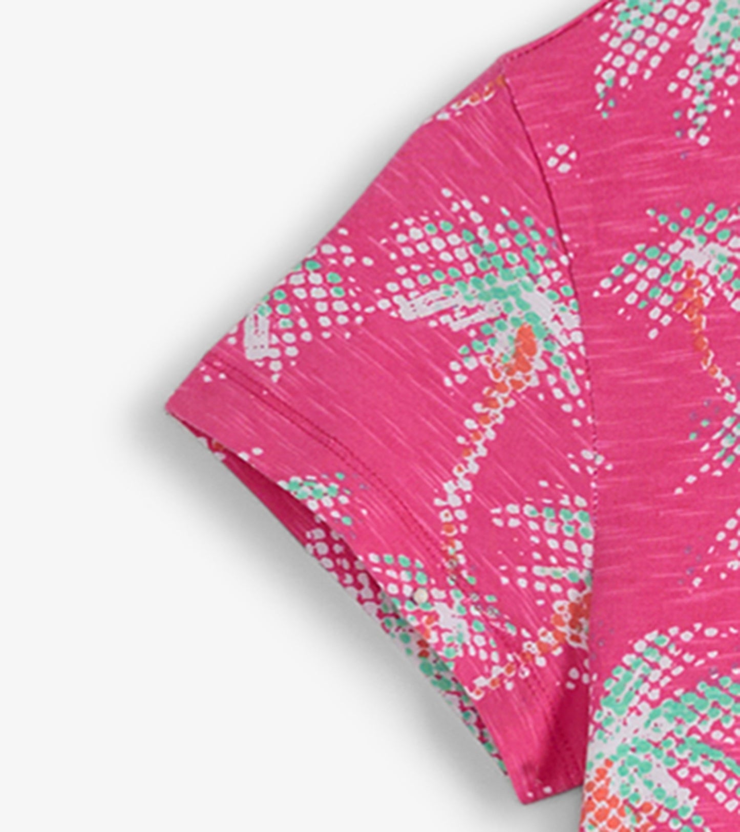 Pink crew neck t-shirt dress featuring a palm tree pattern in green and white, with short sleeves and a relaxed fit.