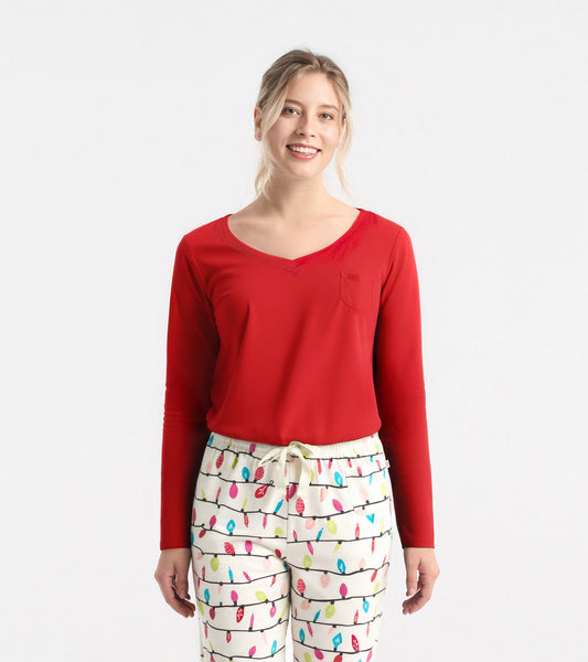 Red long sleeve polyknit t-shirt with a v-neck and a small pocket, styled with patterned pajama pants.