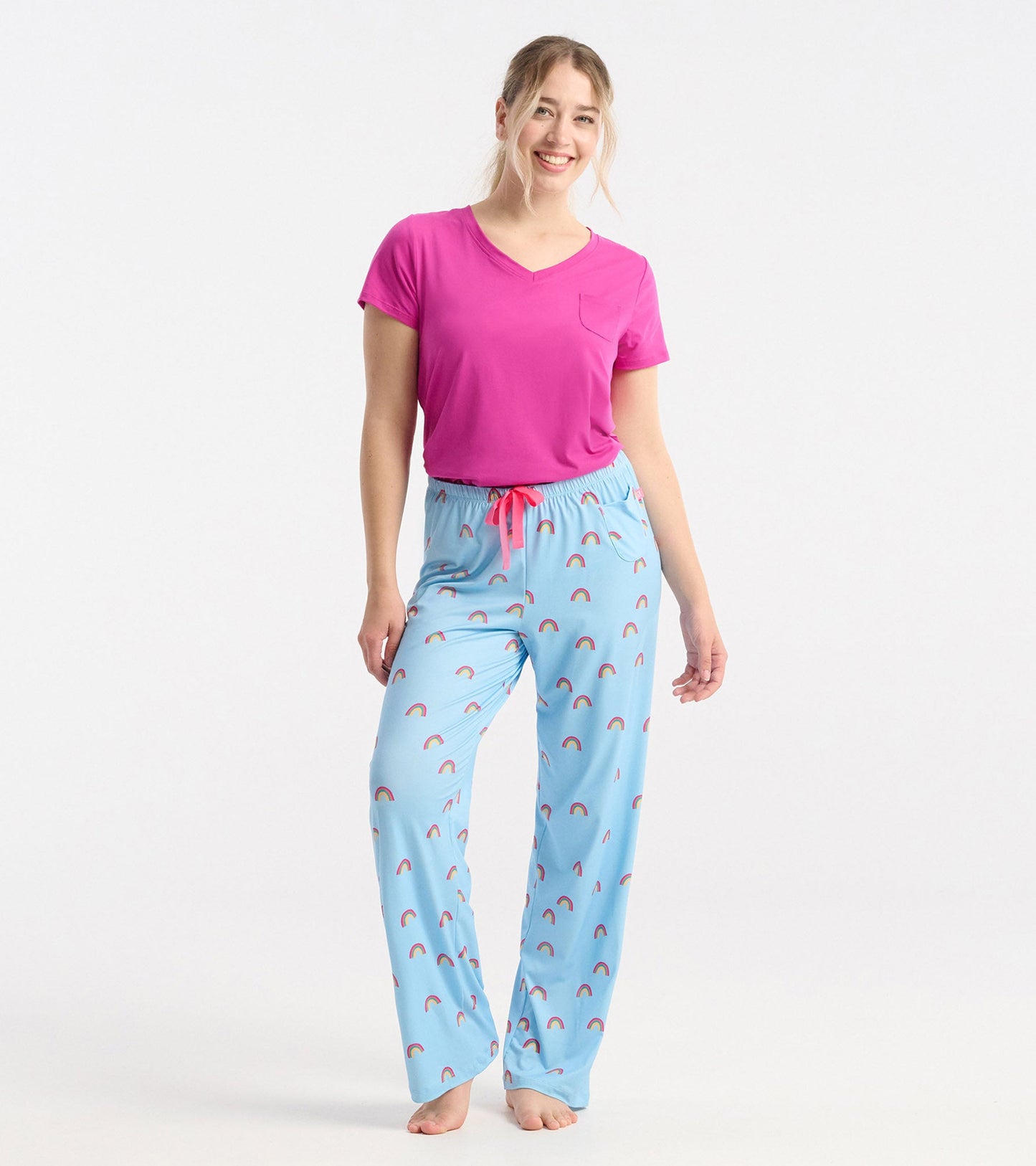 Vibrant rose violet V-neck T-shirt with short sleeves, paired with light blue pajama pants featuring rainbow patterns.