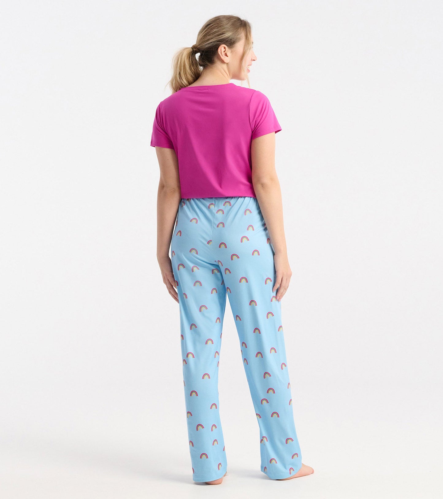 Vibrant rose violet V-neck T-shirt paired with light blue pants featuring a rainbow pattern, shown from the back.