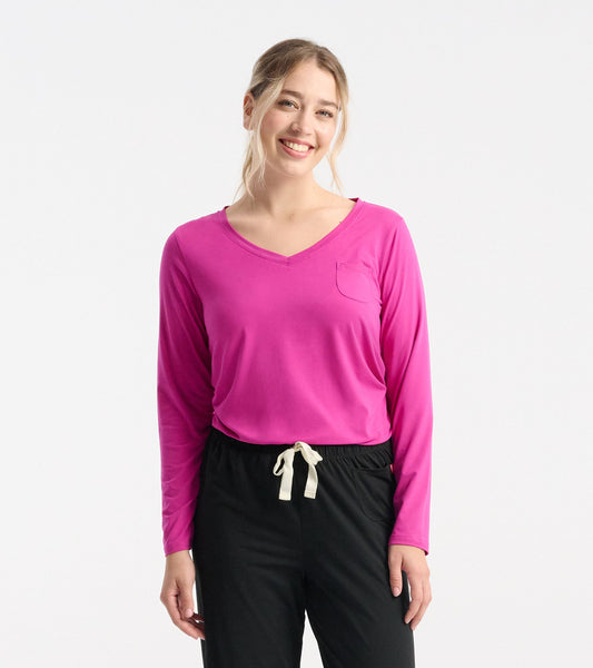 Long sleeve t-shirt in vibrant rose violet with a v-neck and pocket detail, styled with black pants.