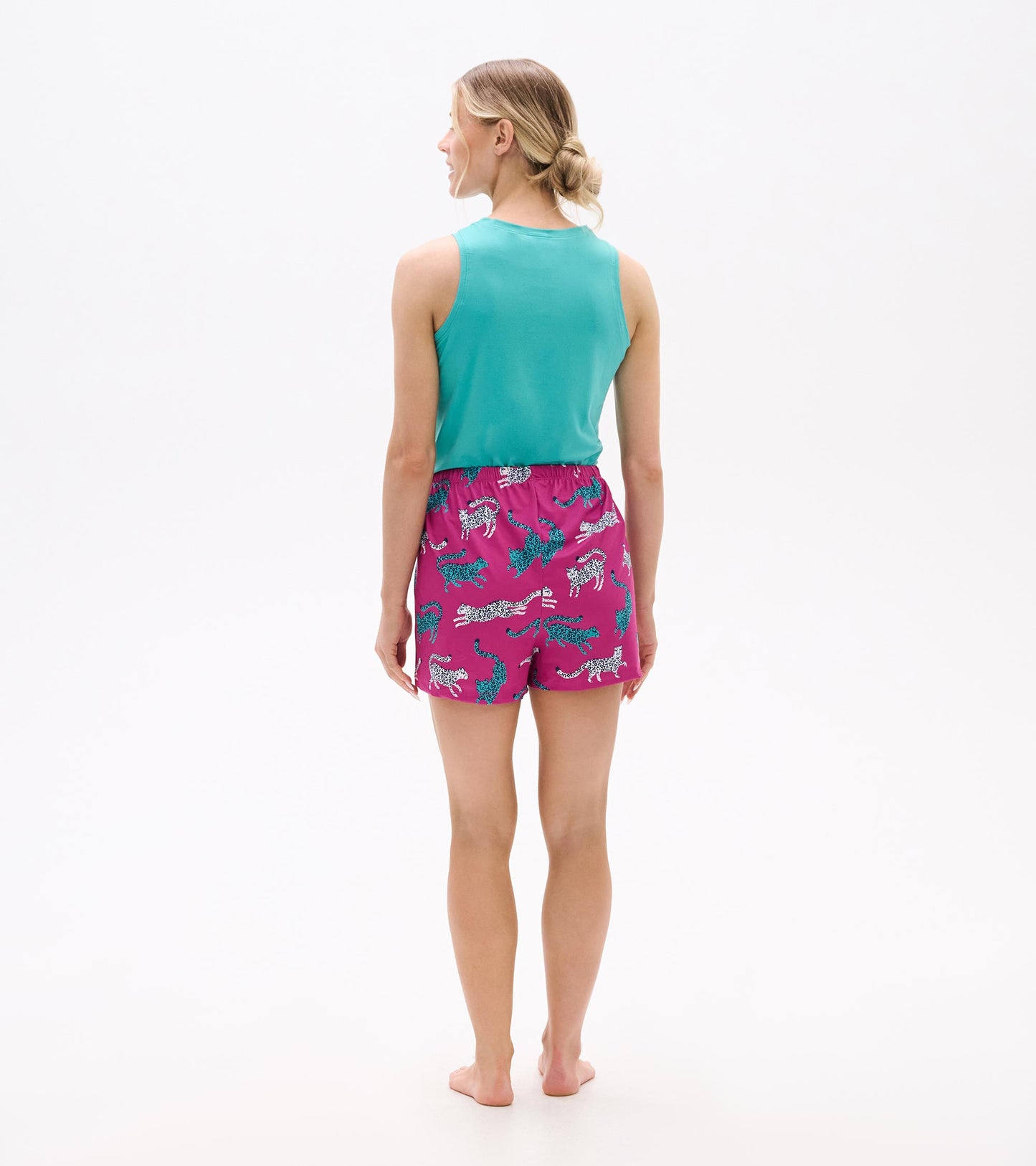 Back view of women's pajama shorts featuring a vibrant pink color with a cheetah print pattern.