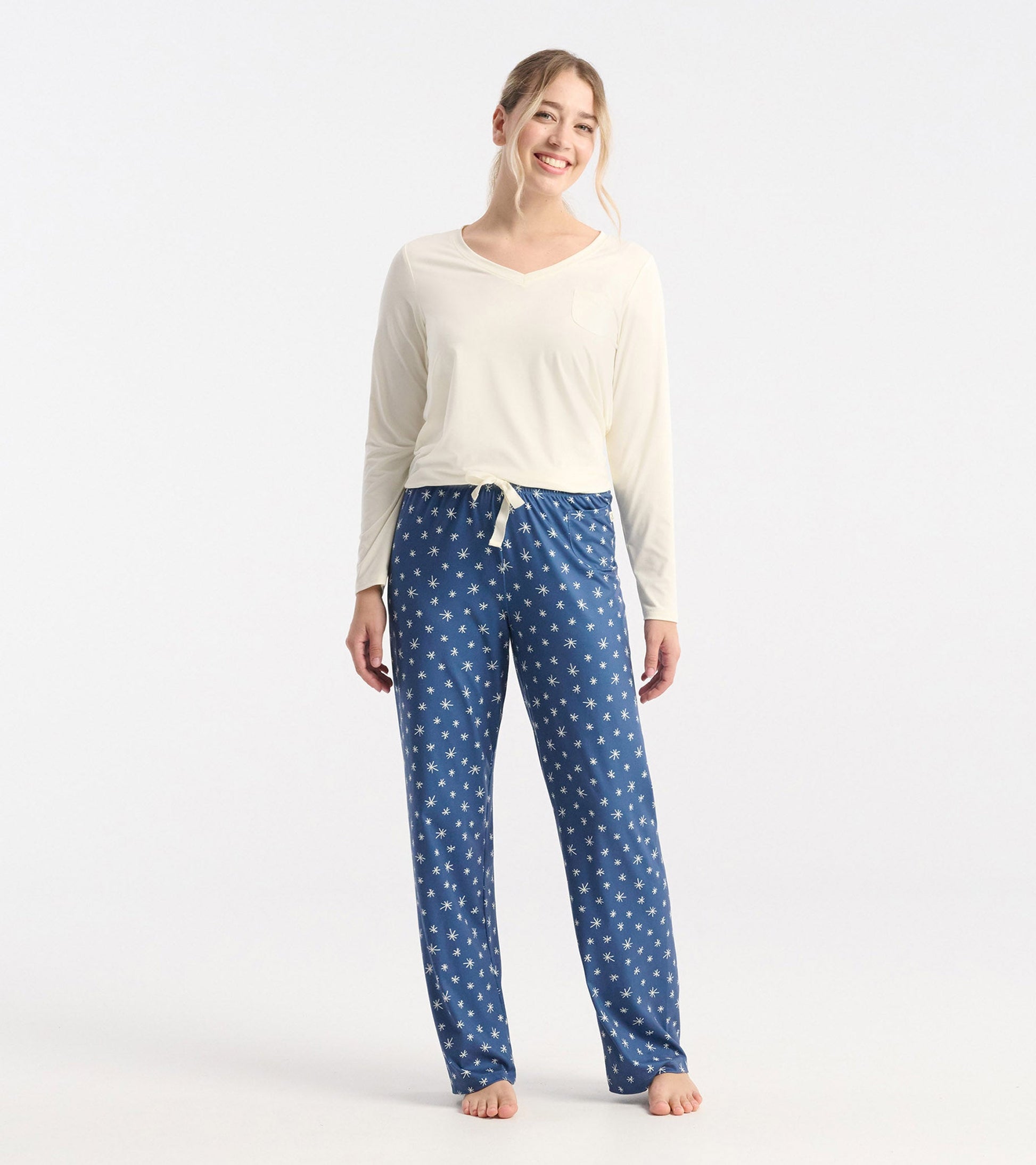 Blue polyknit pajama pants featuring a snowflake pattern, with a relaxed fit and drawstring waist.