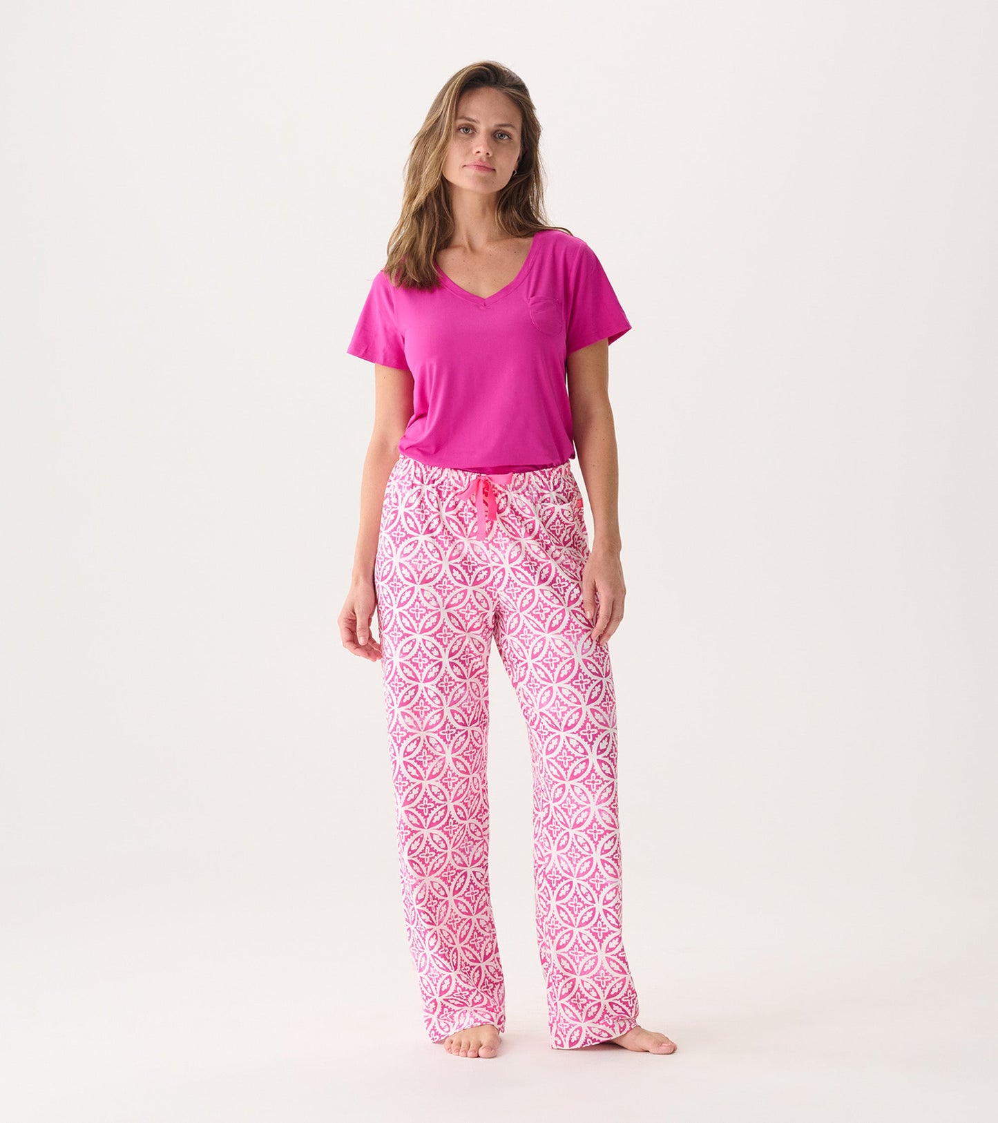 Women's pink pajama pants featuring a lotus mandala pattern, made from soft polyknit fabric, with a comfortable fit.