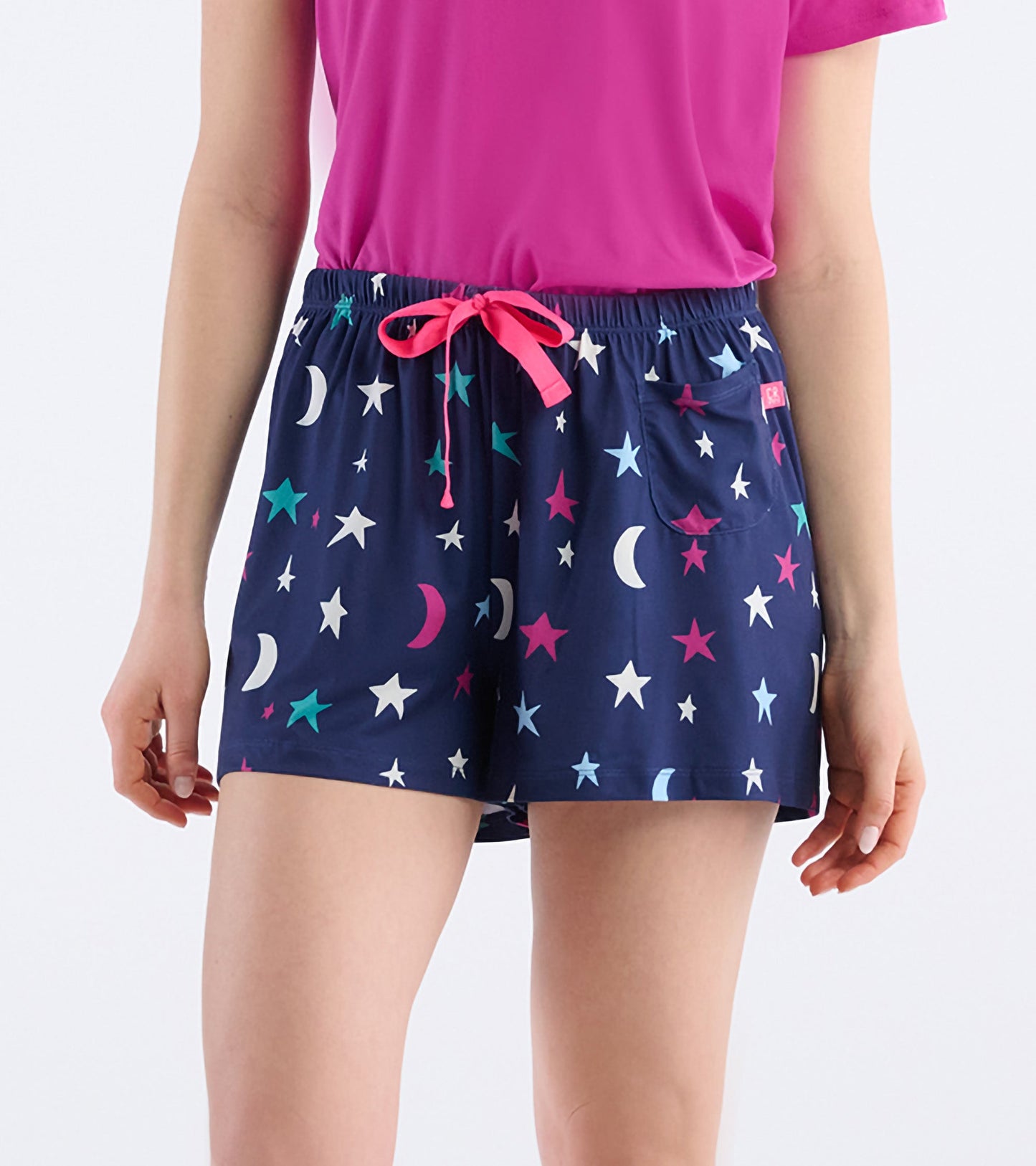 Navy pajama shorts with colorful stars and moons, featuring an elastic waistband and drawstring.