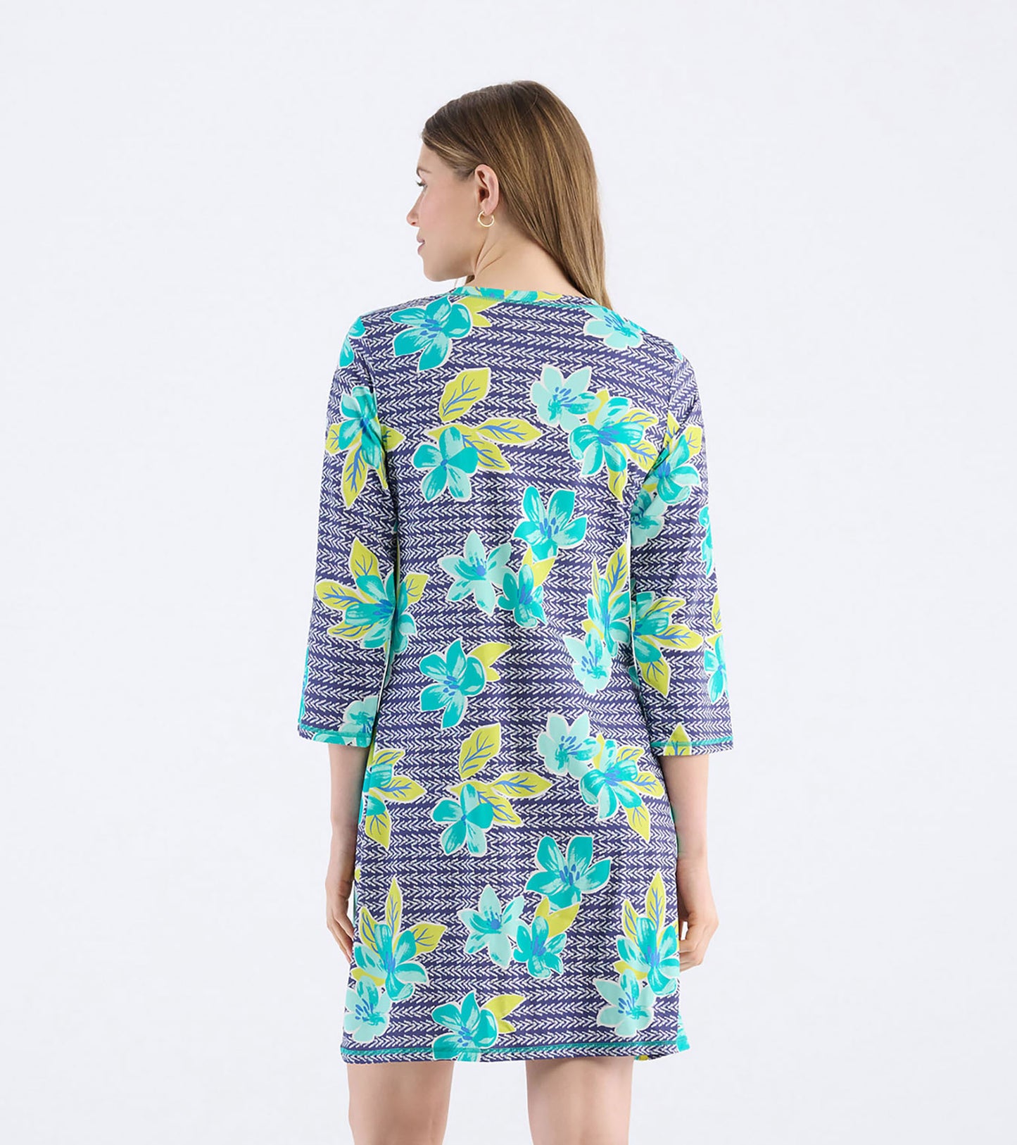 Back view of a women's dress featuring a bold floral pattern in turquoise and yellow on a navy background.