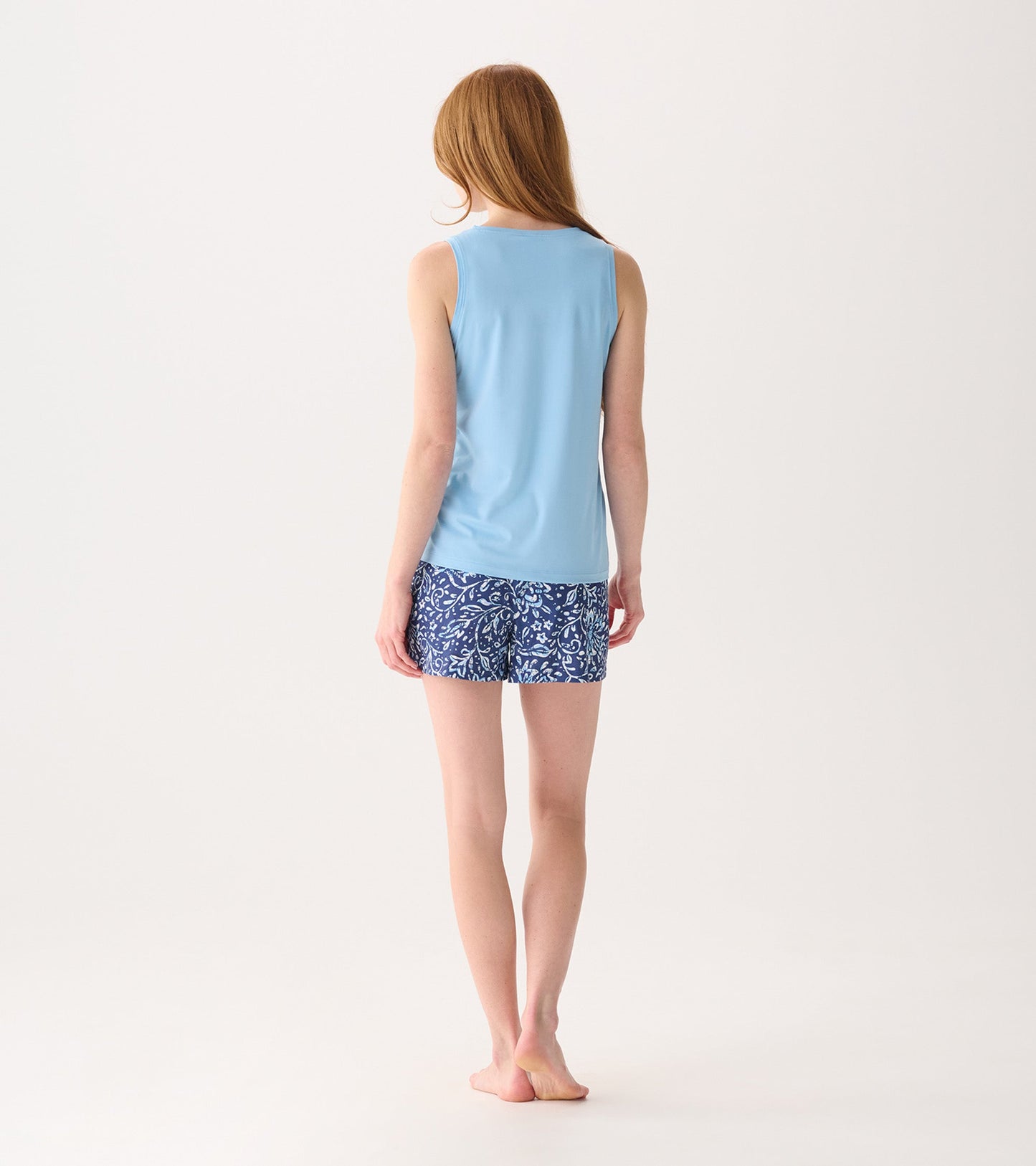 Light blue sleeveless top paired with navy shorts featuring a white batik floral pattern, viewed from the back.