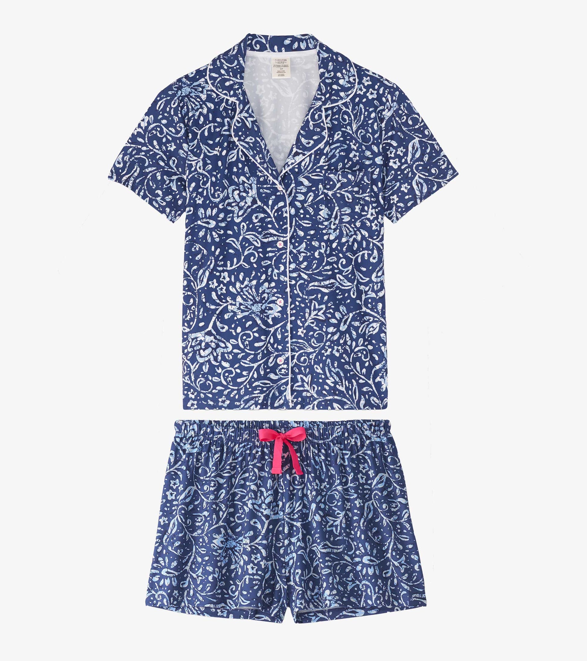Navy short pajama set featuring a floral batik pattern, with a button-up top and elastic waistband shorts.