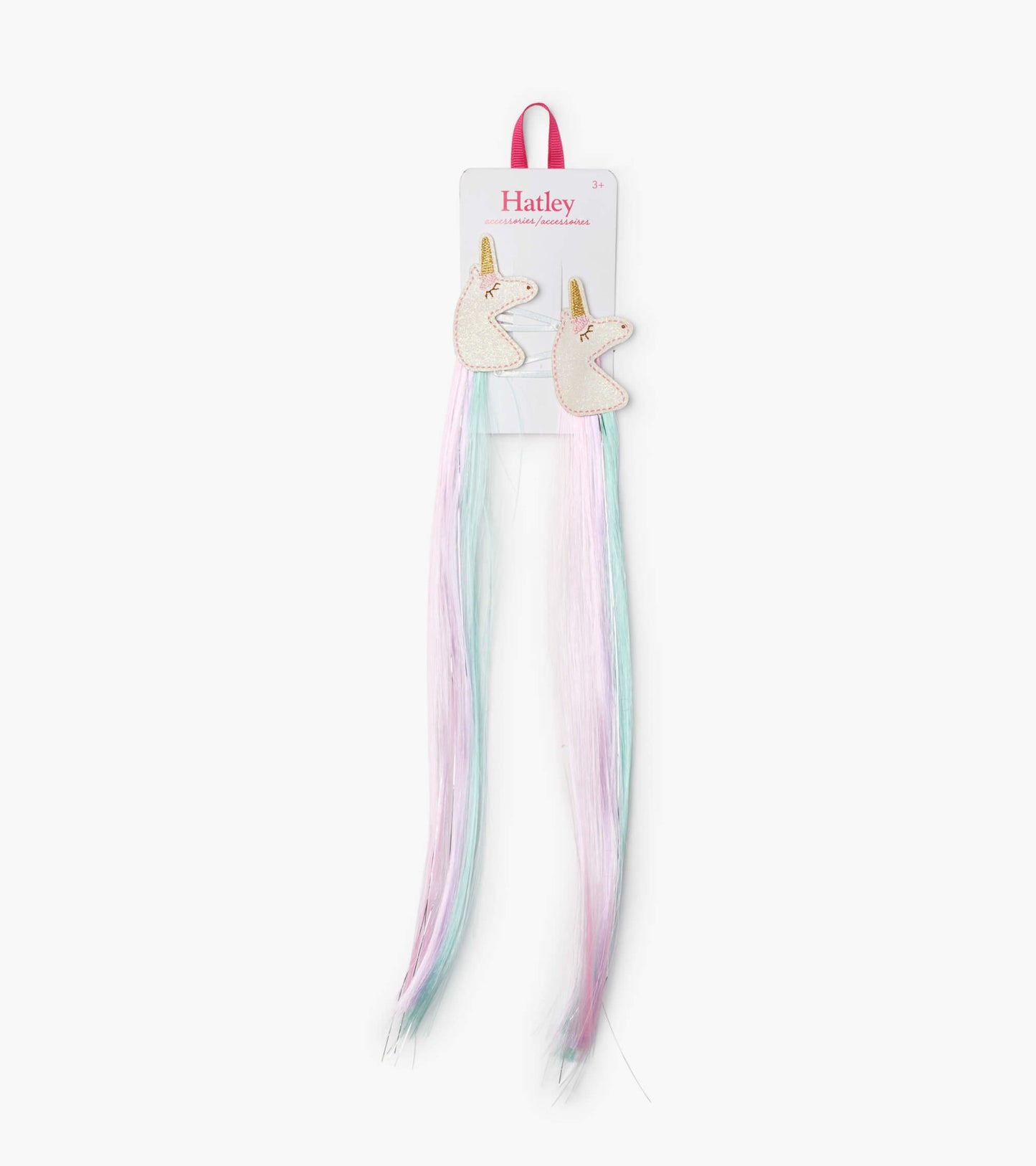 Two unicorn-shaped hair clips with pastel pink and blue faux hair extensions.