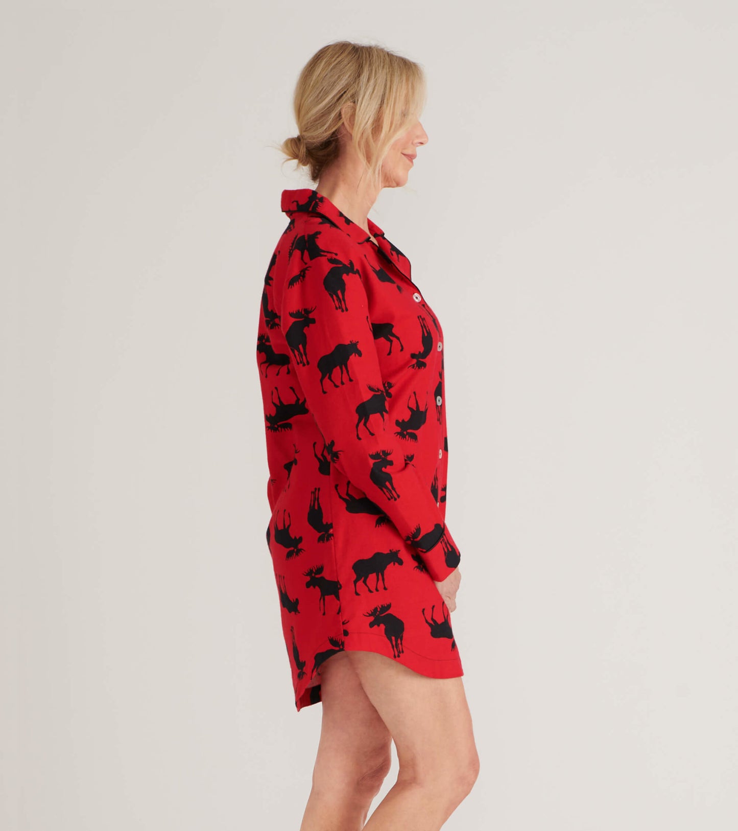 Red flannel nightgown featuring a black moose pattern, button-up front, and long sleeves, shown from the side.