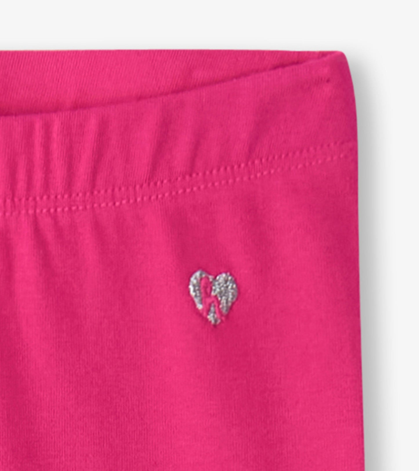Fuschia bike shorts with an elastic waistband and a small silver heart logo on the side.