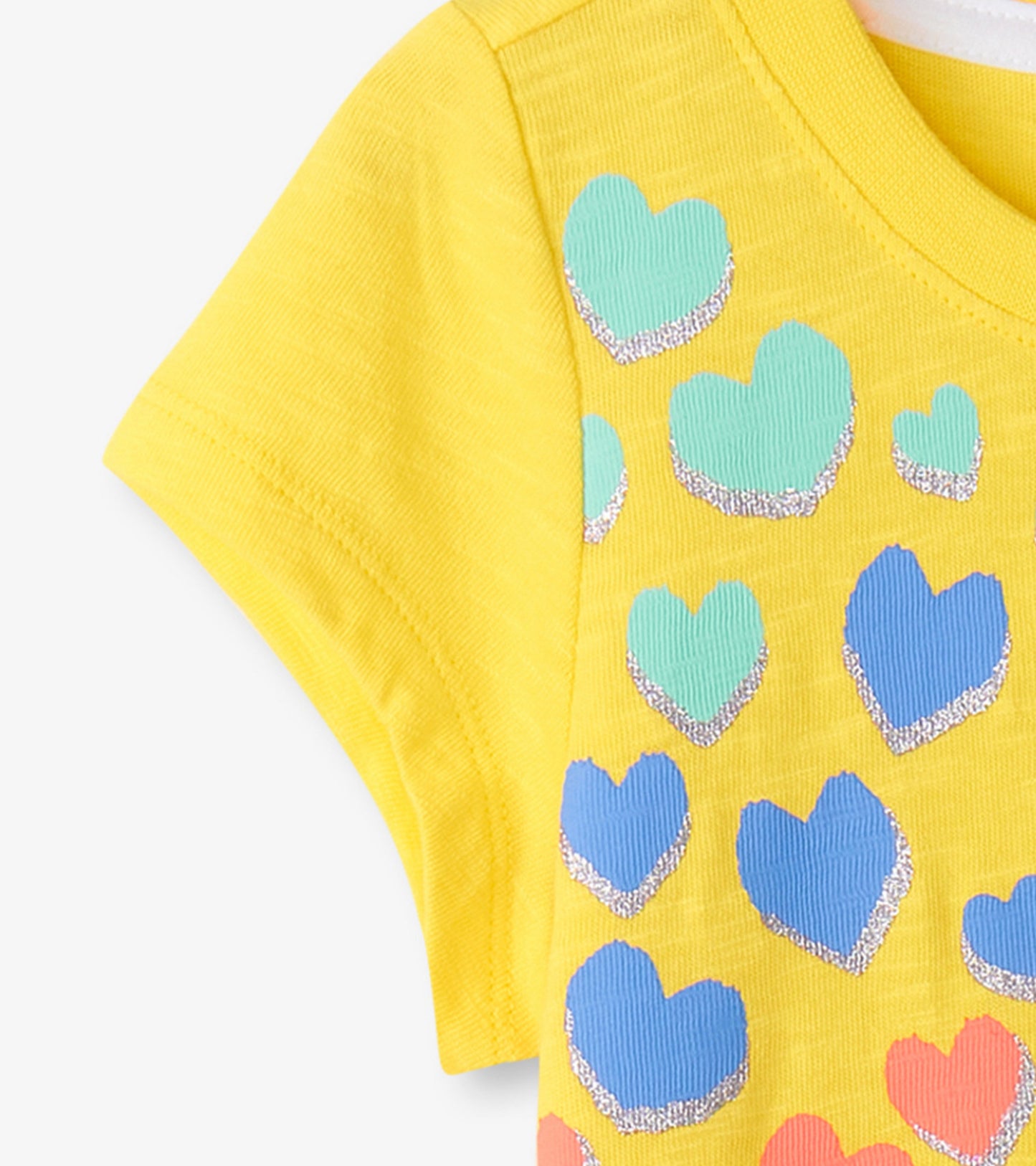Yellow graphic tee featuring colorful hearts in various sizes and a soft, ribbed texture.