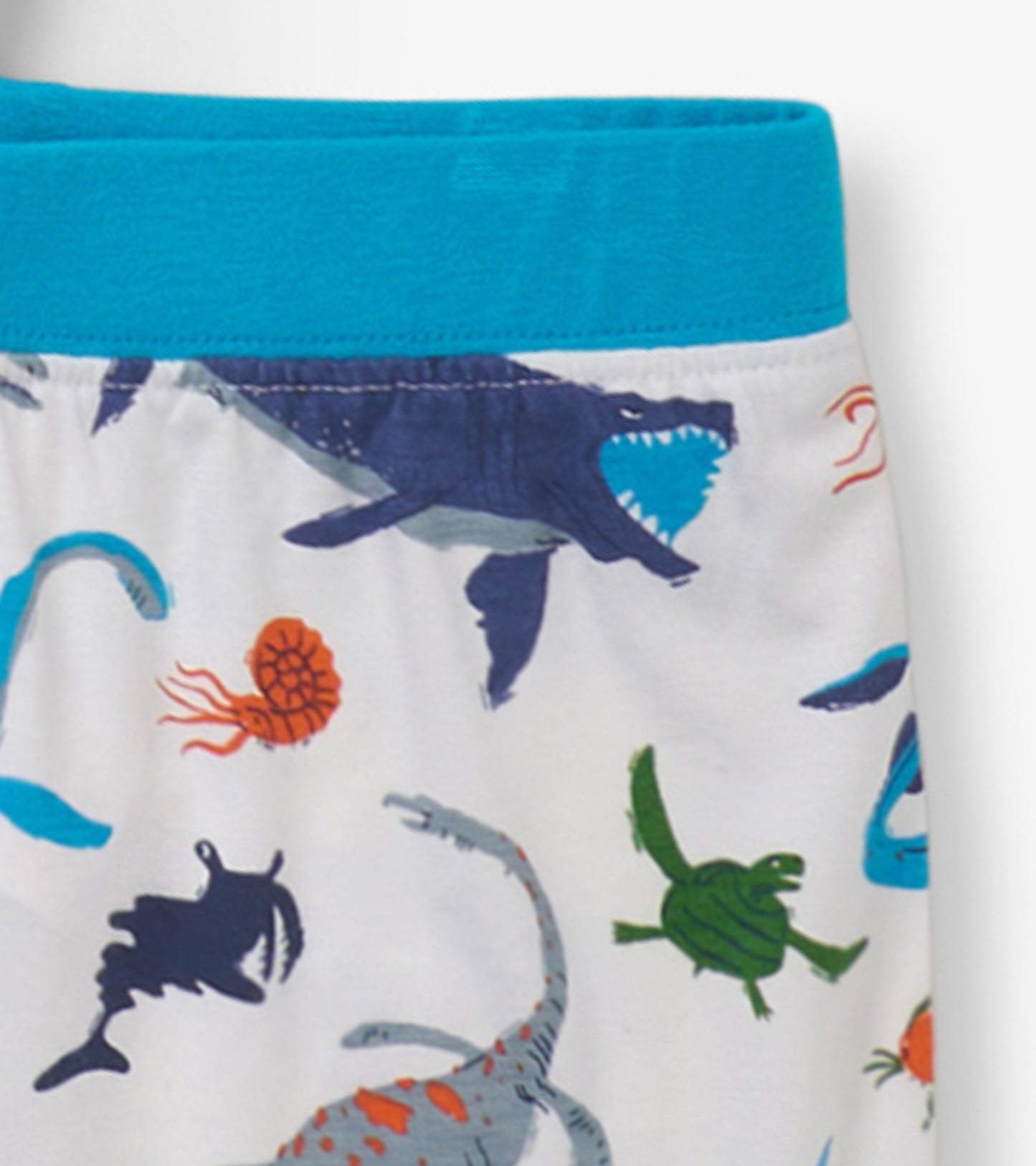 Boys' short pajama set featuring a white base with colorful prehistoric marine animal prints and a turquoise waistband.