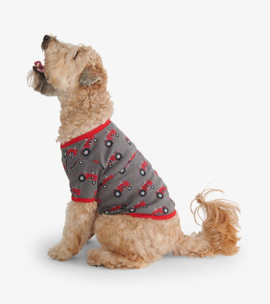 Gray dog tee featuring red tractor prints and a red collar, shown on a dog sitting sideways.