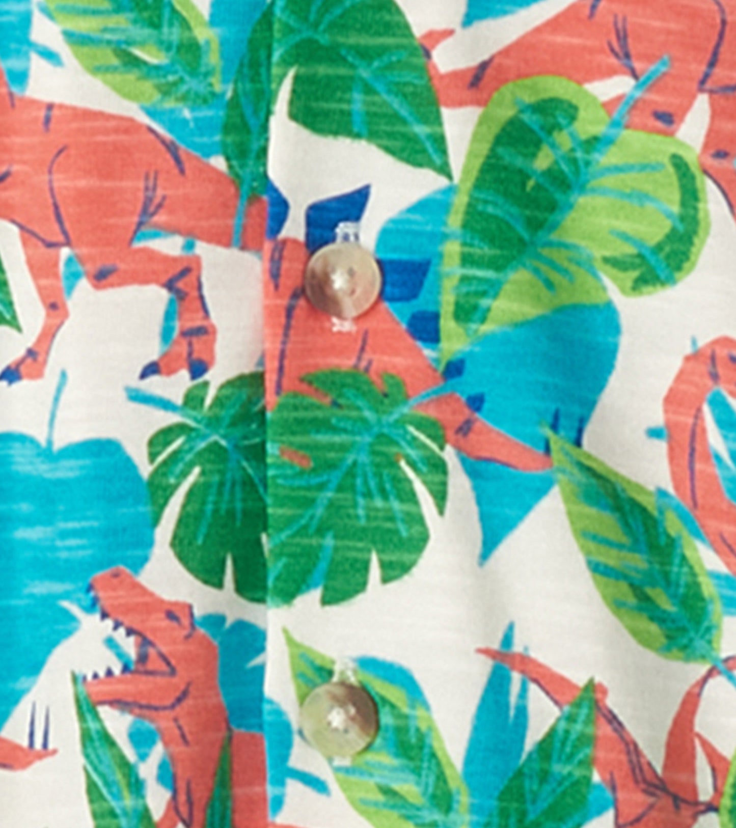 Short sleeve button-down shirt featuring a colorful dinosaur and leaf pattern on a light background.