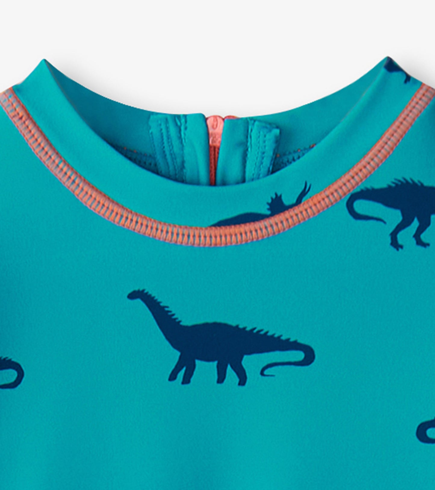 Turquoise one-piece rashguard featuring dark blue dinosaur silhouettes and a contrasting orange neckline.