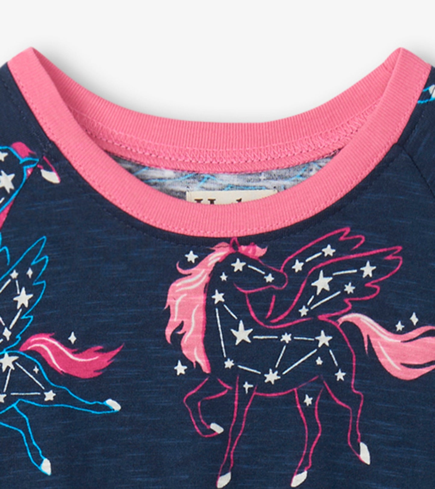 Navy dress featuring colorful unicorn constellations and a pink ribbed neckline.