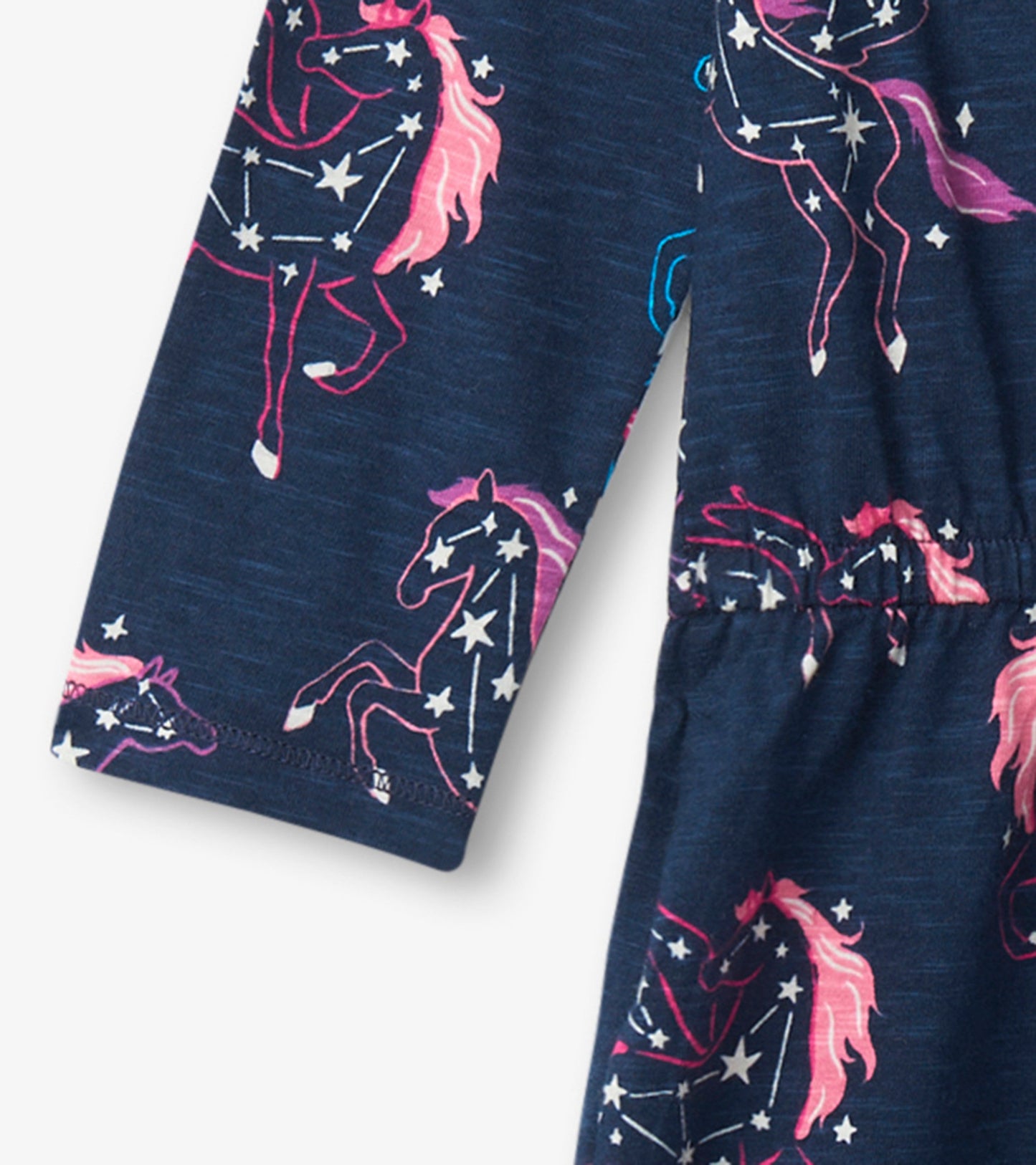 Navy drop waist dress featuring colorful unicorn and star patterns, made from soft fabric with long sleeves.