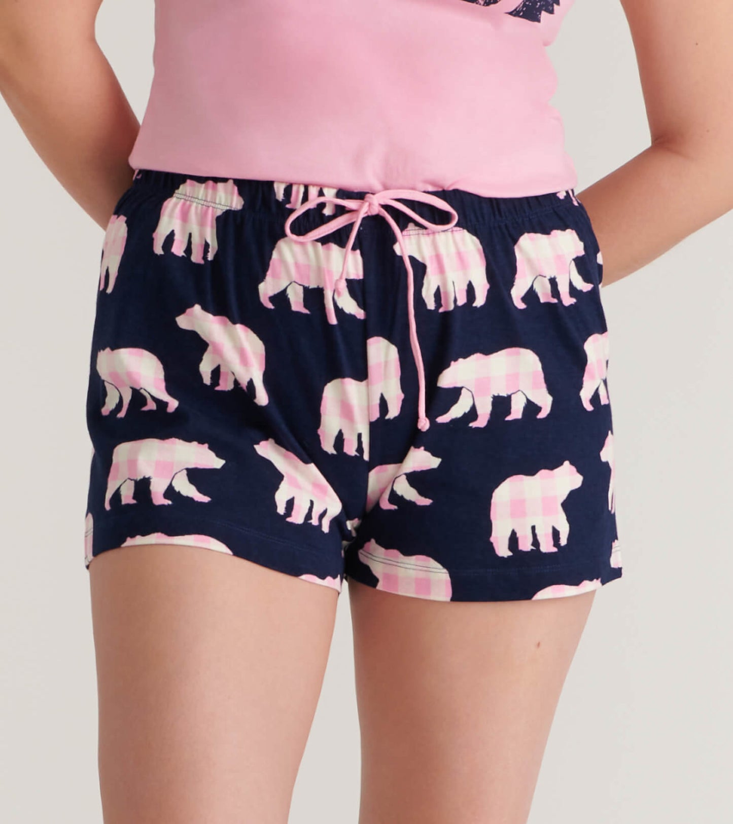 Navy cotton sleep shorts featuring a pink bear pattern and an elastic waistband with a drawstring.