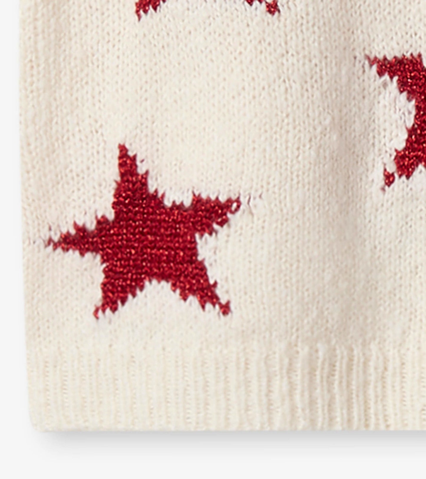 Cream sweater dress featuring red star patterns, perfect for festive occasions.