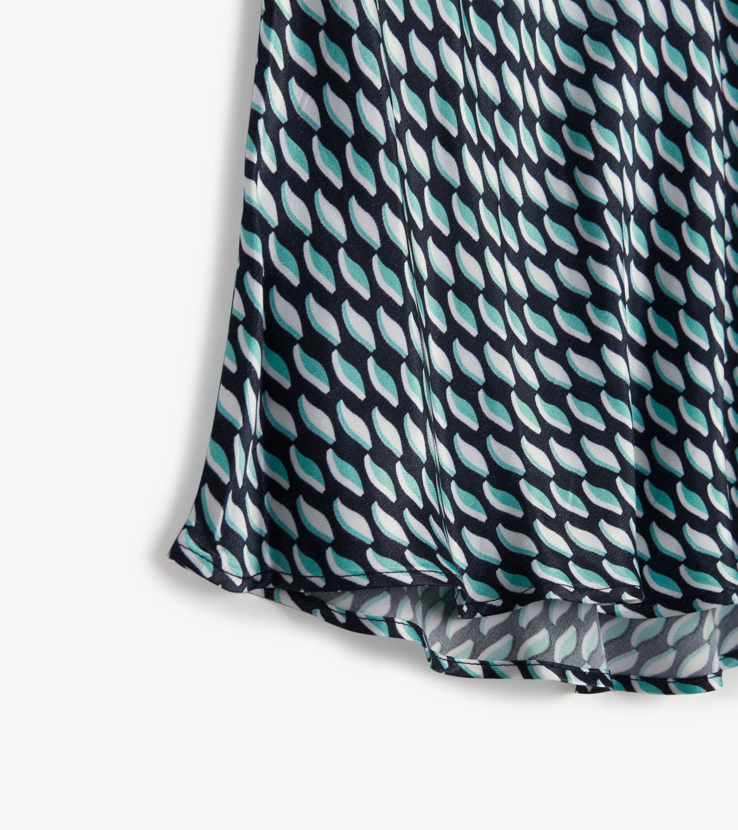 Midi skirt featuring a graphic leaf pattern in teal and white on a dark background, with a flowing silhouette.