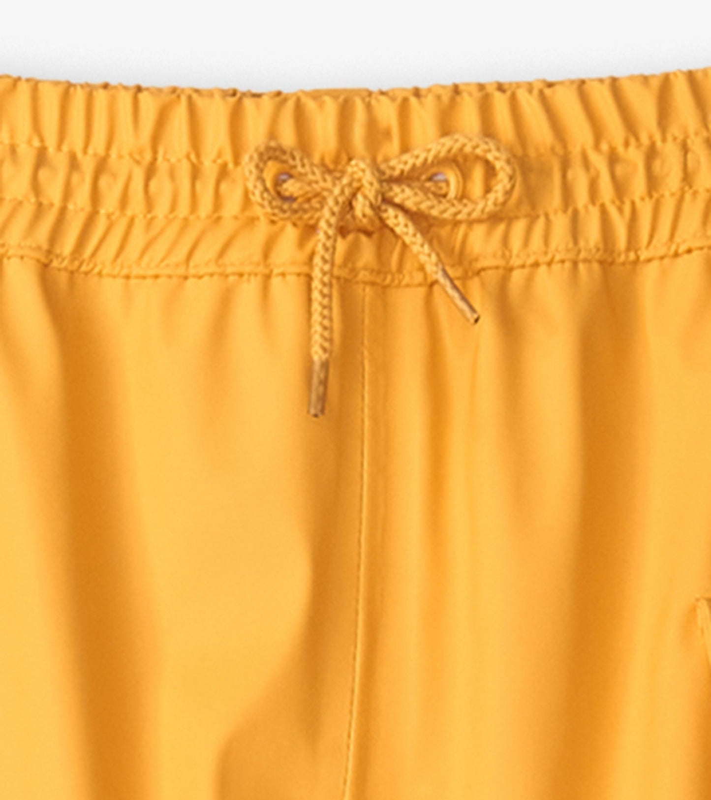 Yellow kids' rain pants with an elastic waistband and drawstring for adjustable fit. Ideal for wet weather activities.