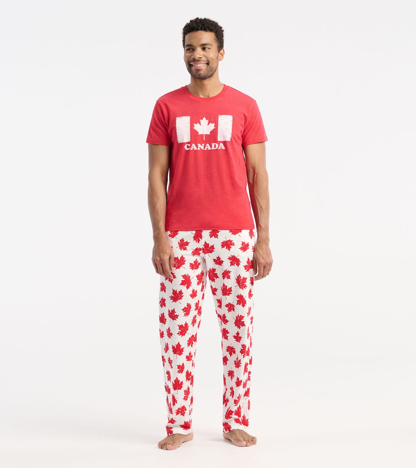 Red short-sleeve tee featuring a white Canadian flag design, paired with white pants adorned with red maple leaves.