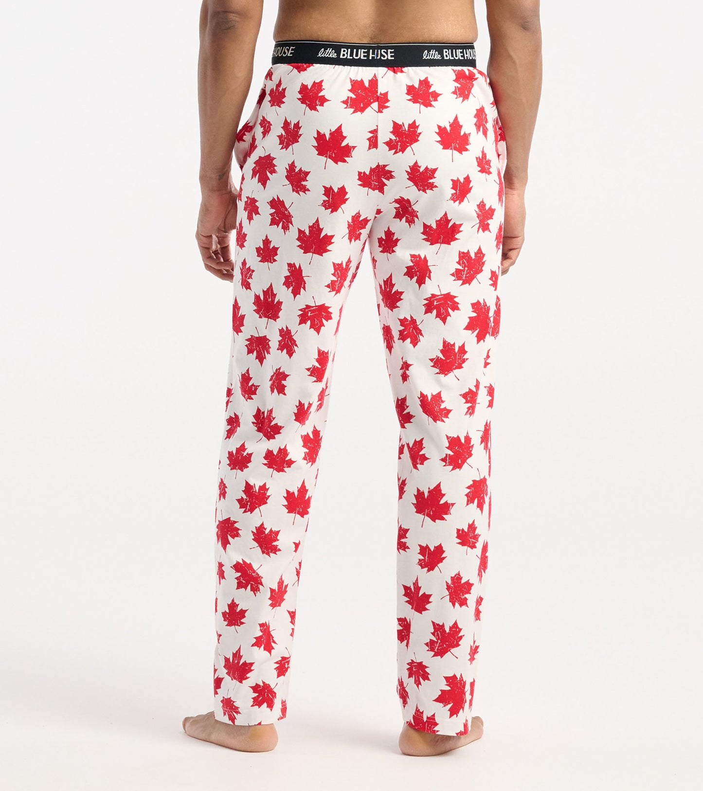Men's cotton pajama pants featuring a white background with red maple leaf patterns and an elastic waistband.