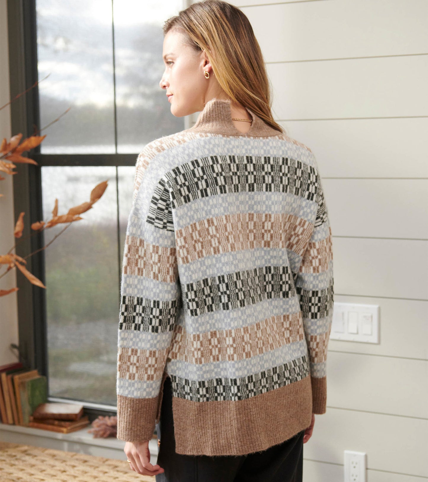 Mock neck sweater featuring a celestial plaid pattern in soft colors, with a relaxed fit and side slits for comfort.