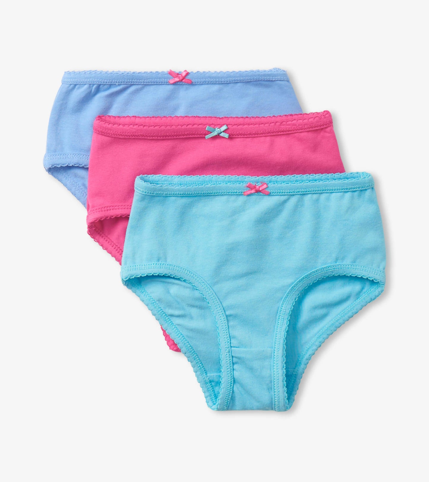 Three pairs of girls' brief underwear in pink, light blue, and blue, featuring bow accents and soft cotton material.