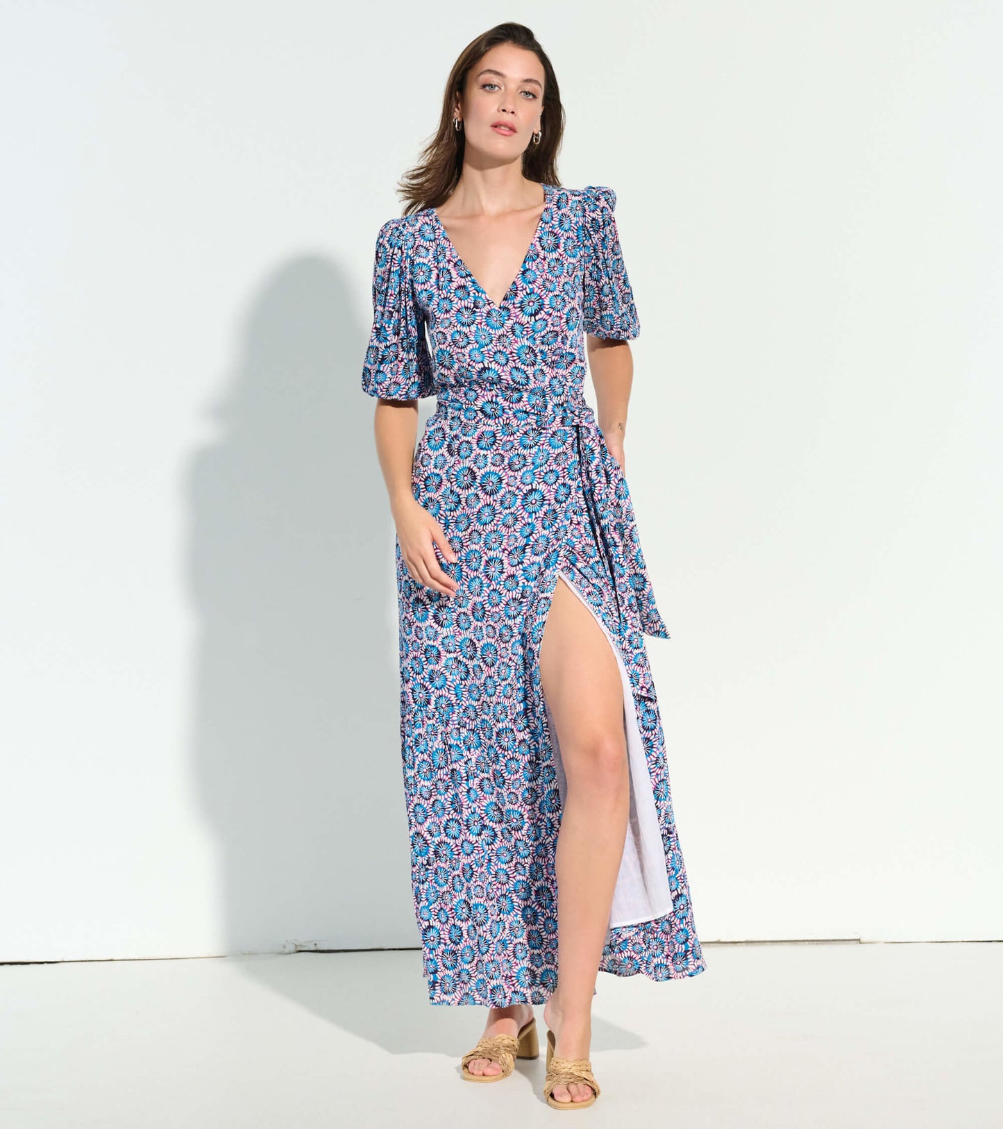 Maxi dress featuring a vibrant sundial mandala pattern, deep V-neck, puff sleeves, and a thigh-high slit.