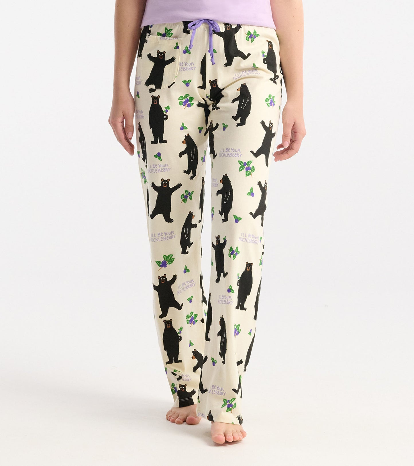 Cream cotton pajama pants featuring a playful black bear and berry pattern, with a purple drawstring waist.