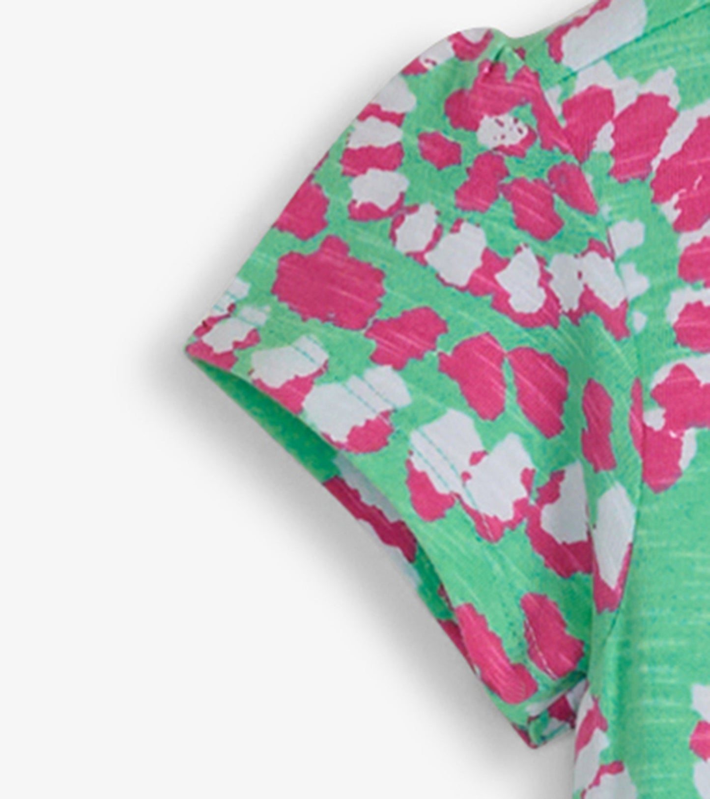 Green t-shirt dress with a vibrant pink and white mandala pattern, featuring short sleeves and a relaxed fit.