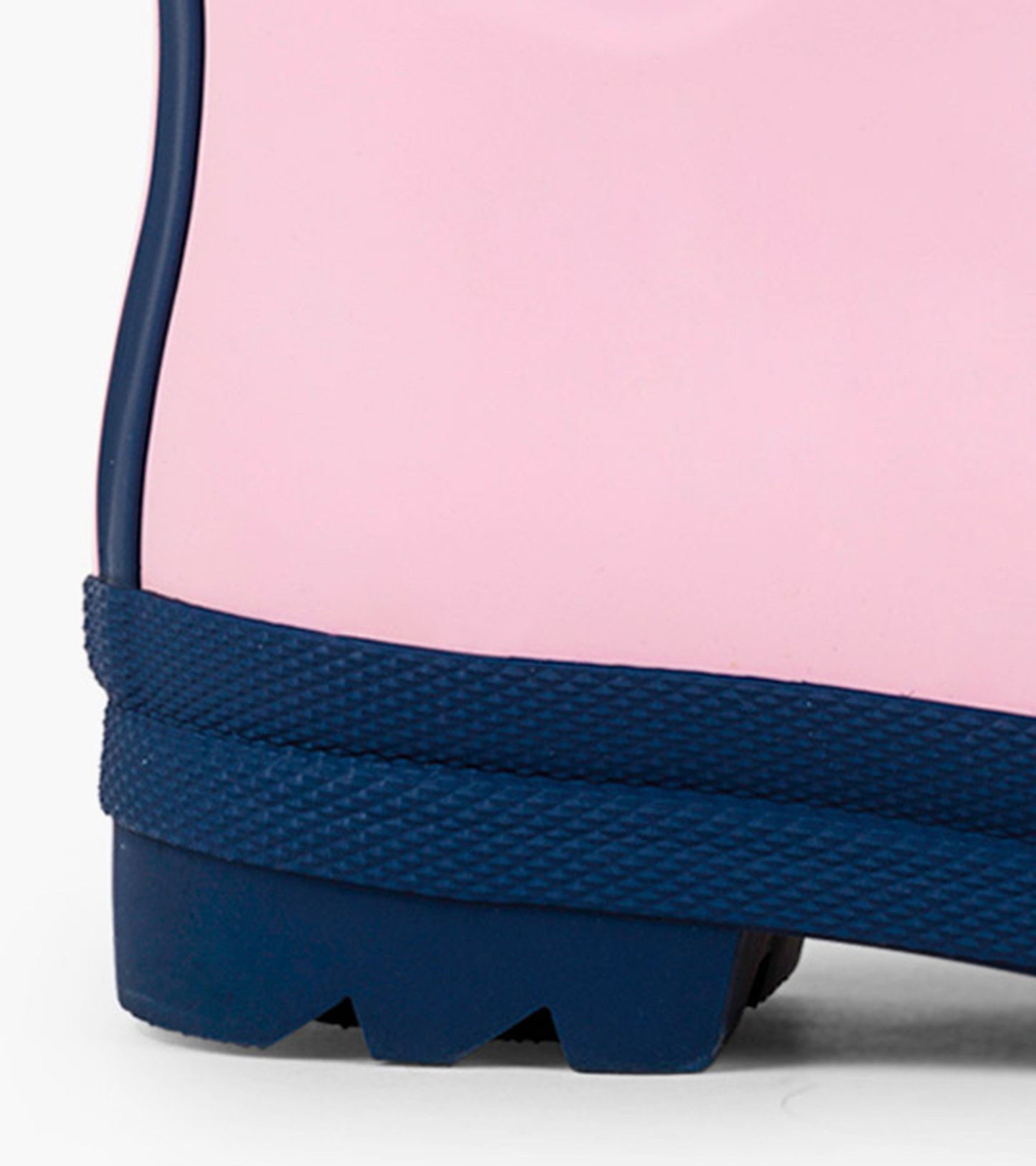Pink and navy matte rain boot with textured sole and contrasting rubber trim, designed for kids.