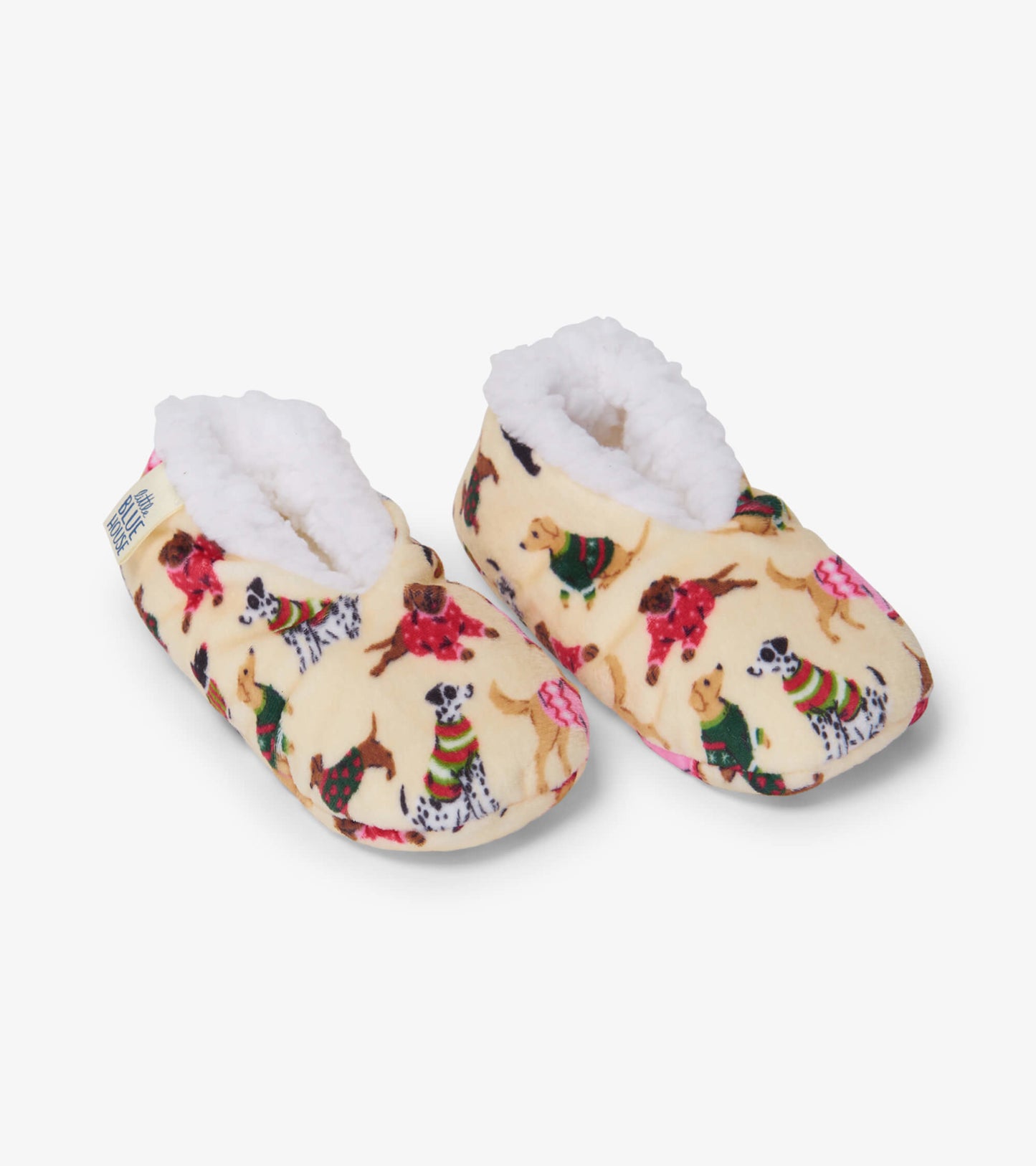 Cozy, cream-colored slippers featuring playful dog patterns and soft, fluffy lining for kids.