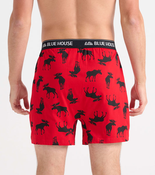 Red men's boxer shorts featuring a black moose pattern, with an elastic waistband and a relaxed fit.
