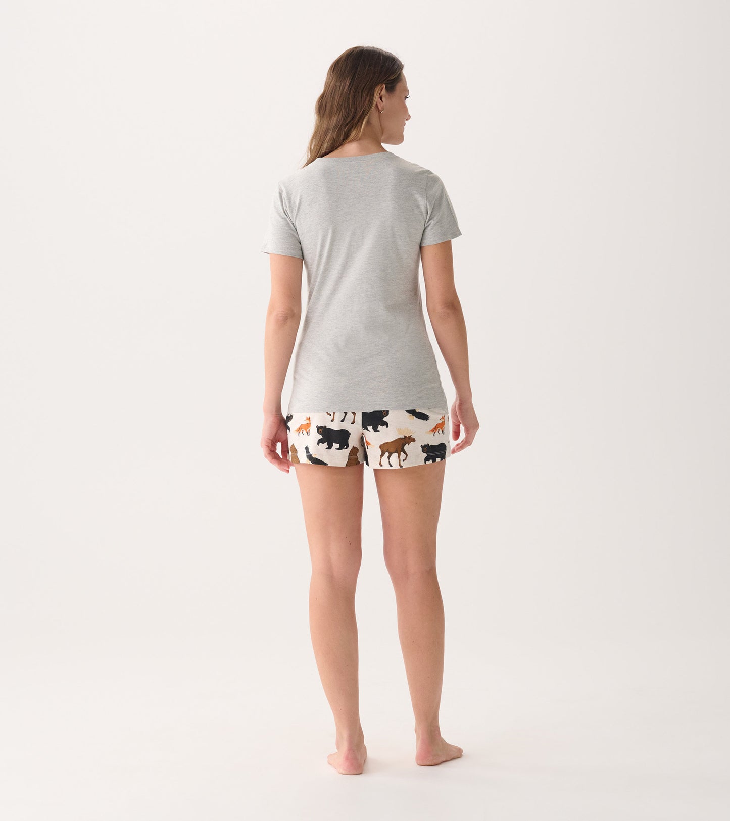 Gray short-sleeve pajama t-shirt paired with patterned shorts featuring wildlife designs. View from the back.