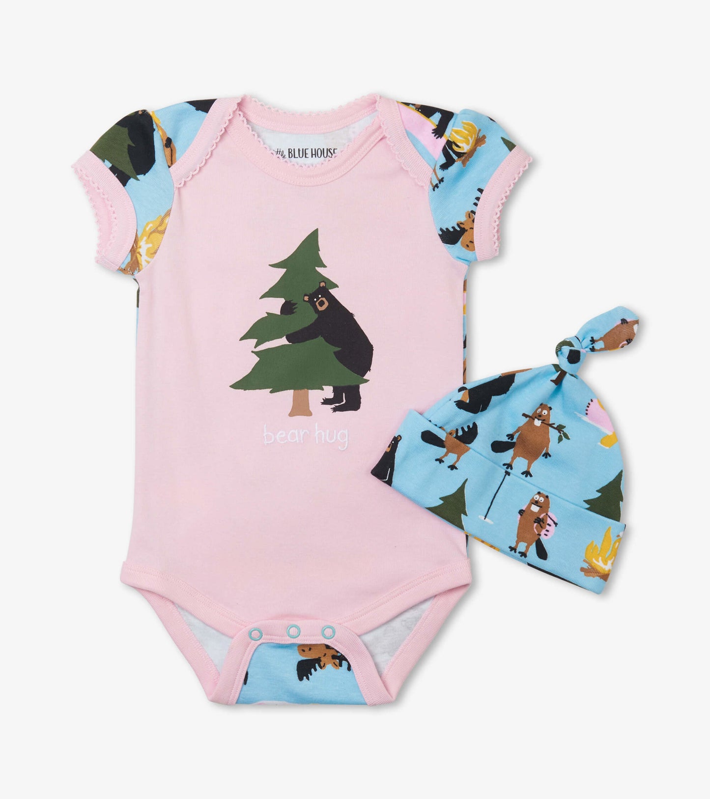 Pink bodysuit with short sleeves featuring a bear and tree design, paired with a blue hat adorned with woodland animals.
