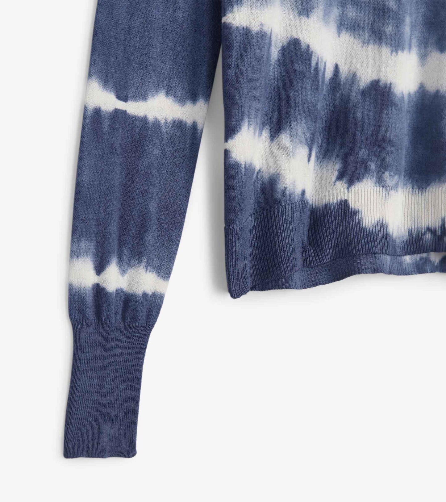 Blue and white tie-dye sweater with ribbed cuffs and hem, showcasing a relaxed fit.