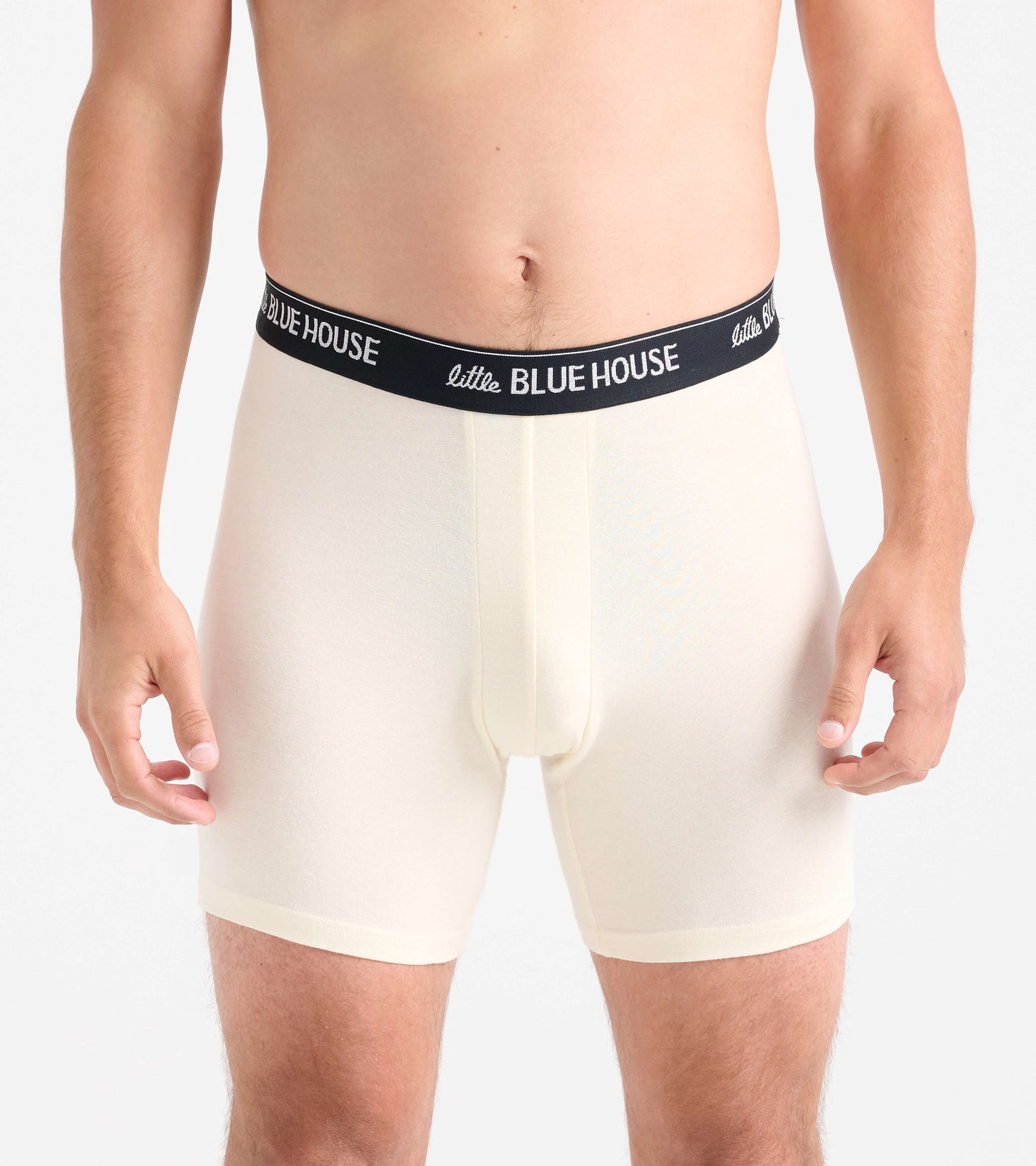 Men's boxer briefs in light cream color with a black waistband, featuring a snug fit and soft material.
