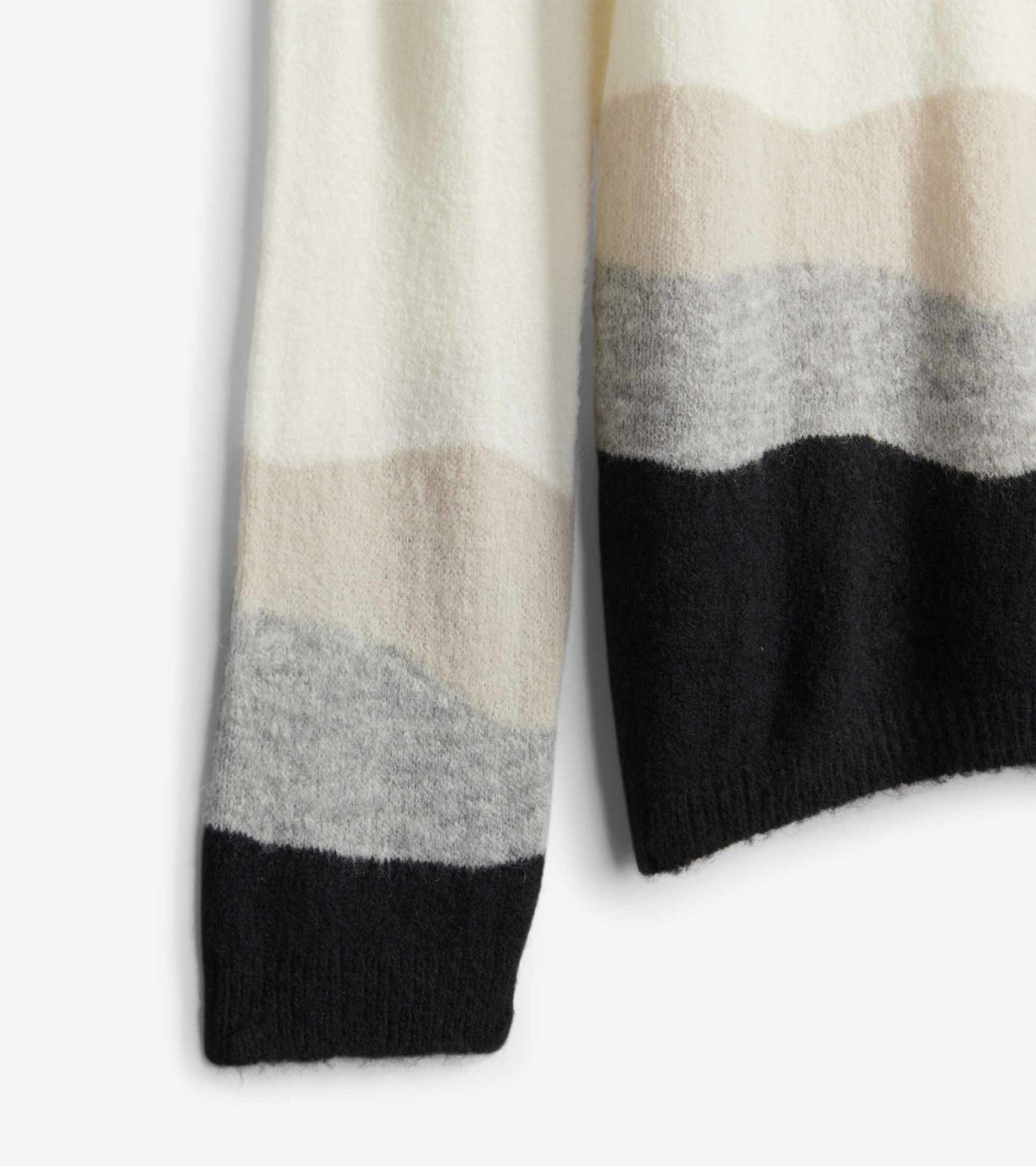 Cream, gray, and black striped sweater with a soft texture, featuring a relaxed fit and long sleeves.
