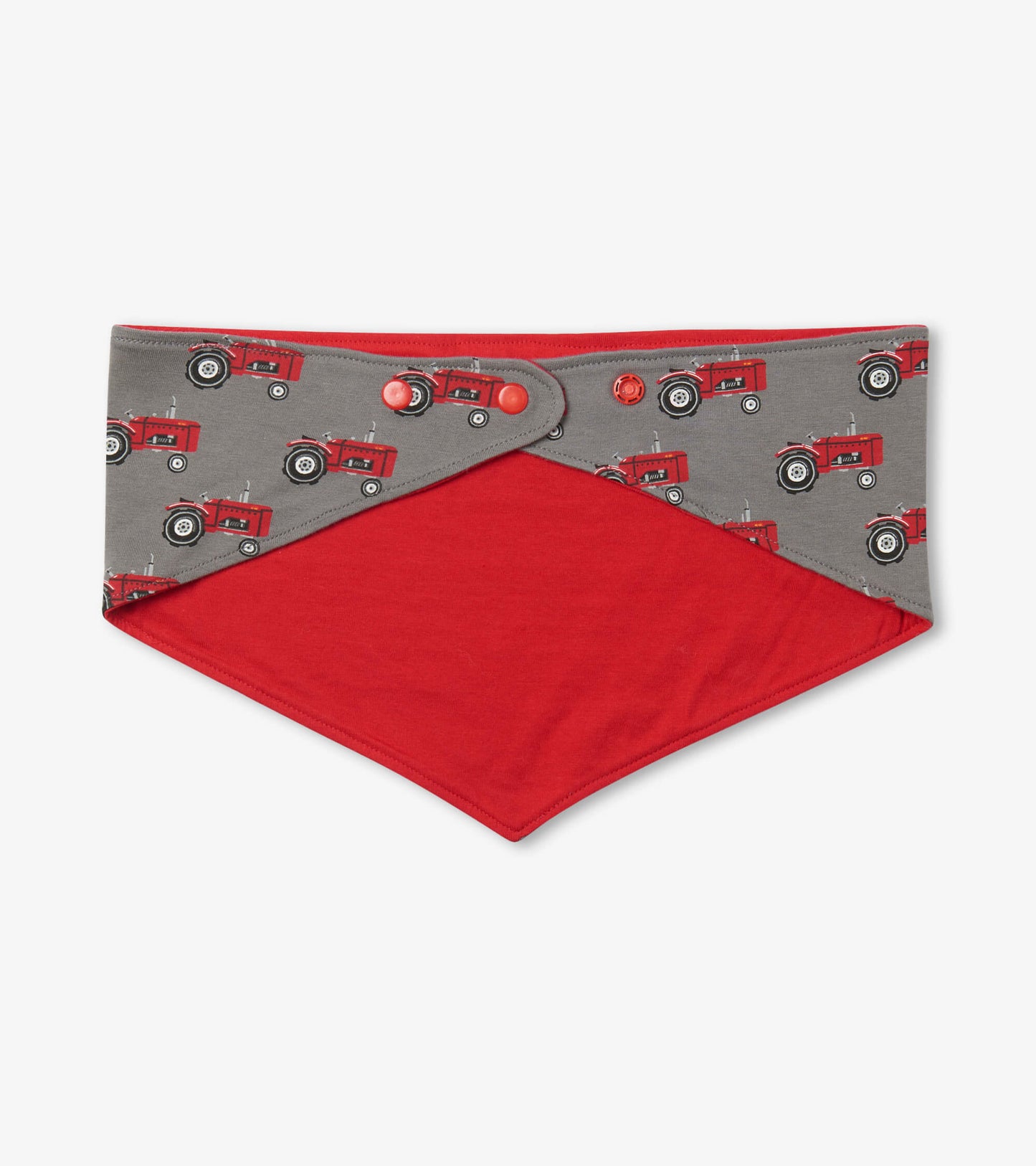 Reversible dog bandana featuring red tractors on a gray background with a solid red underside.