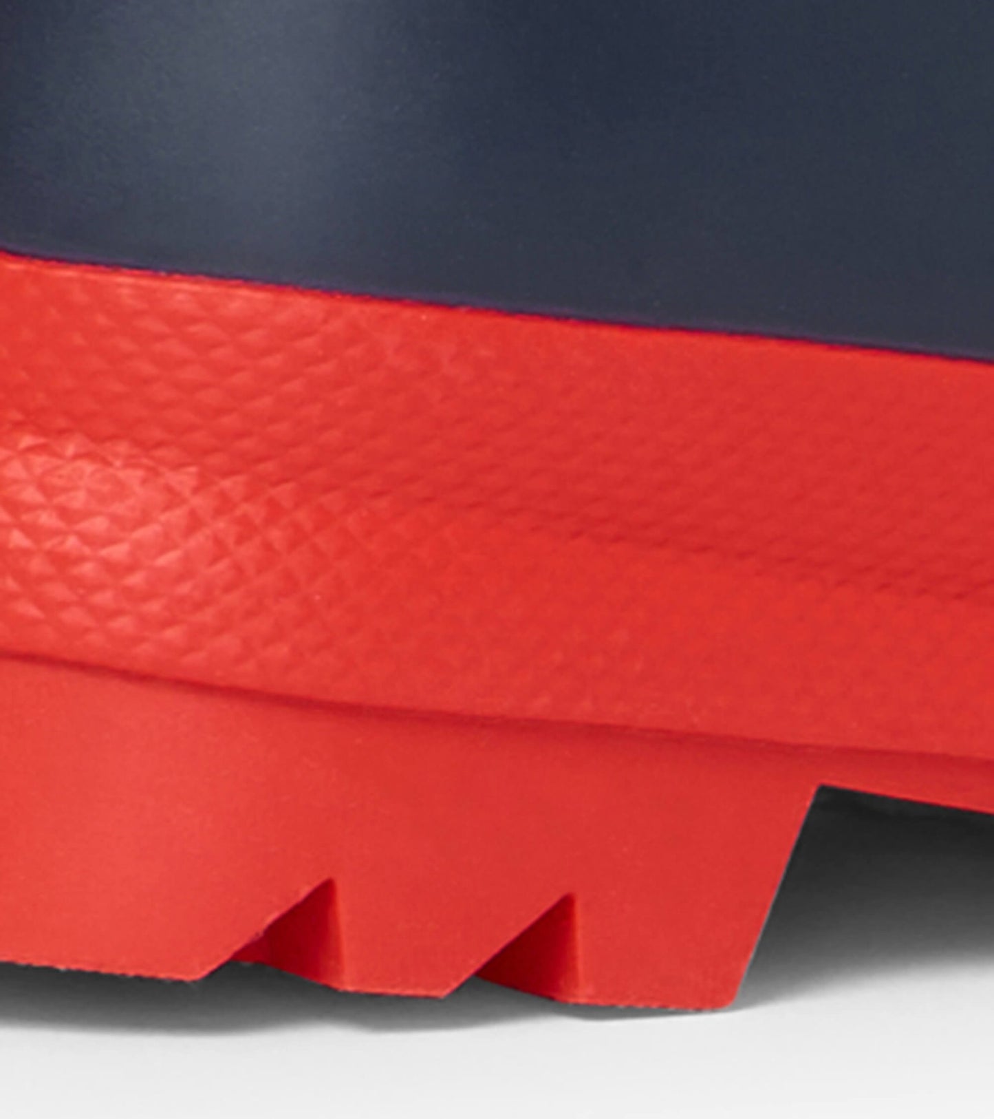 Navy and red matte rain boots with a textured red sole, designed for kids.