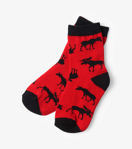 Red crew socks featuring black moose silhouettes, designed for kids aged 2-7.