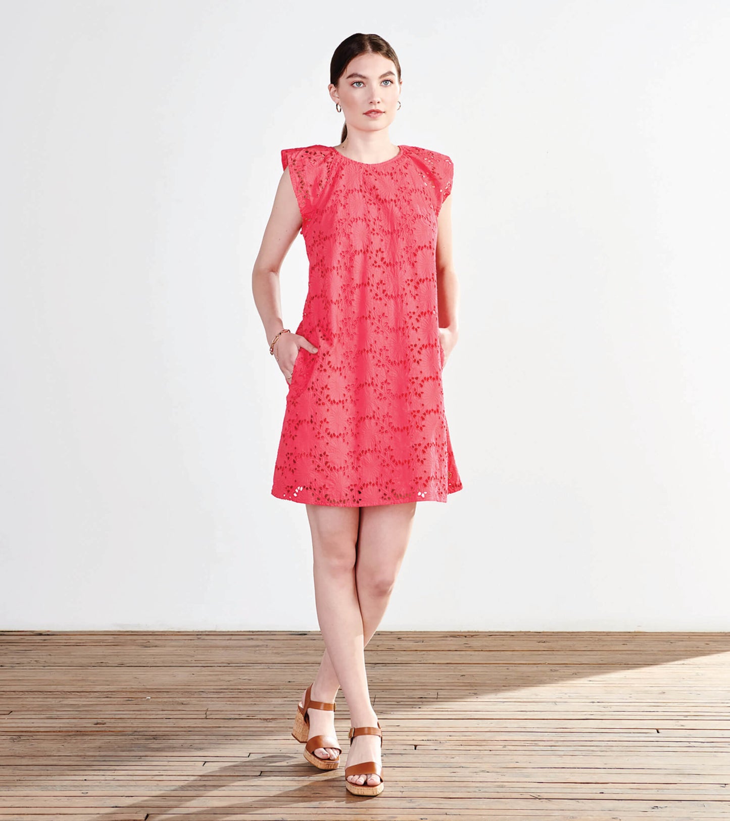 Rouge red eyelet dress with short flutter sleeves and pockets, featuring a relaxed fit and floral pattern.