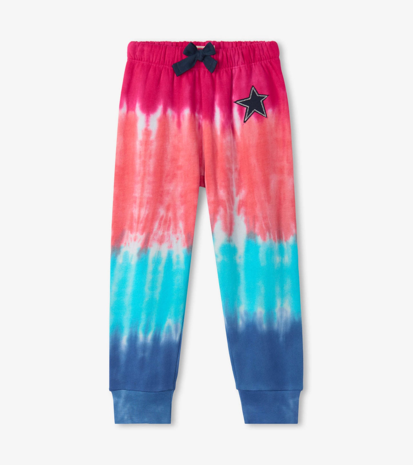 Colorful tie-dye joggers featuring pink, blue, and navy hues with a star patch and elastic waistband.