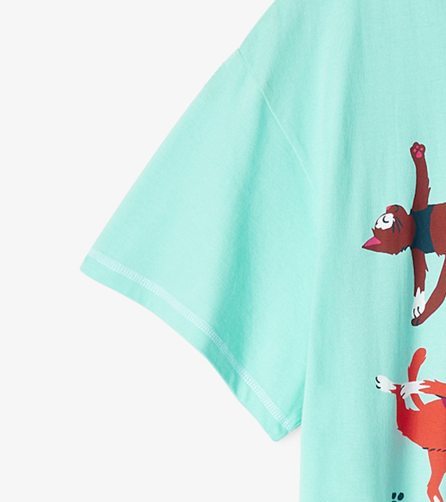Light teal sleepshirt with short sleeves featuring playful cat graphics in various yoga poses.