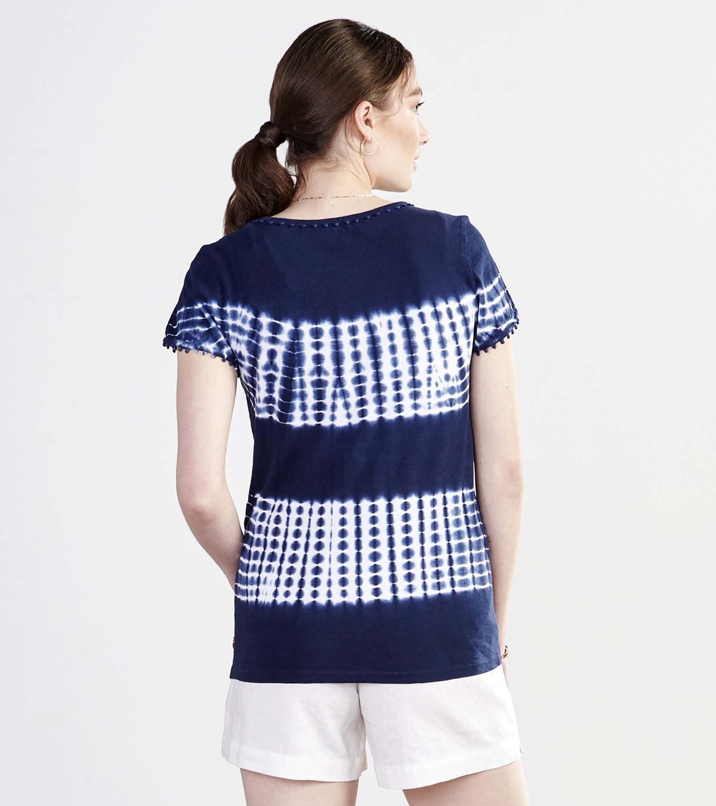Navy blue tie-dye tee with white patterns, featuring short sleeves and a relaxed fit, viewed from the back.