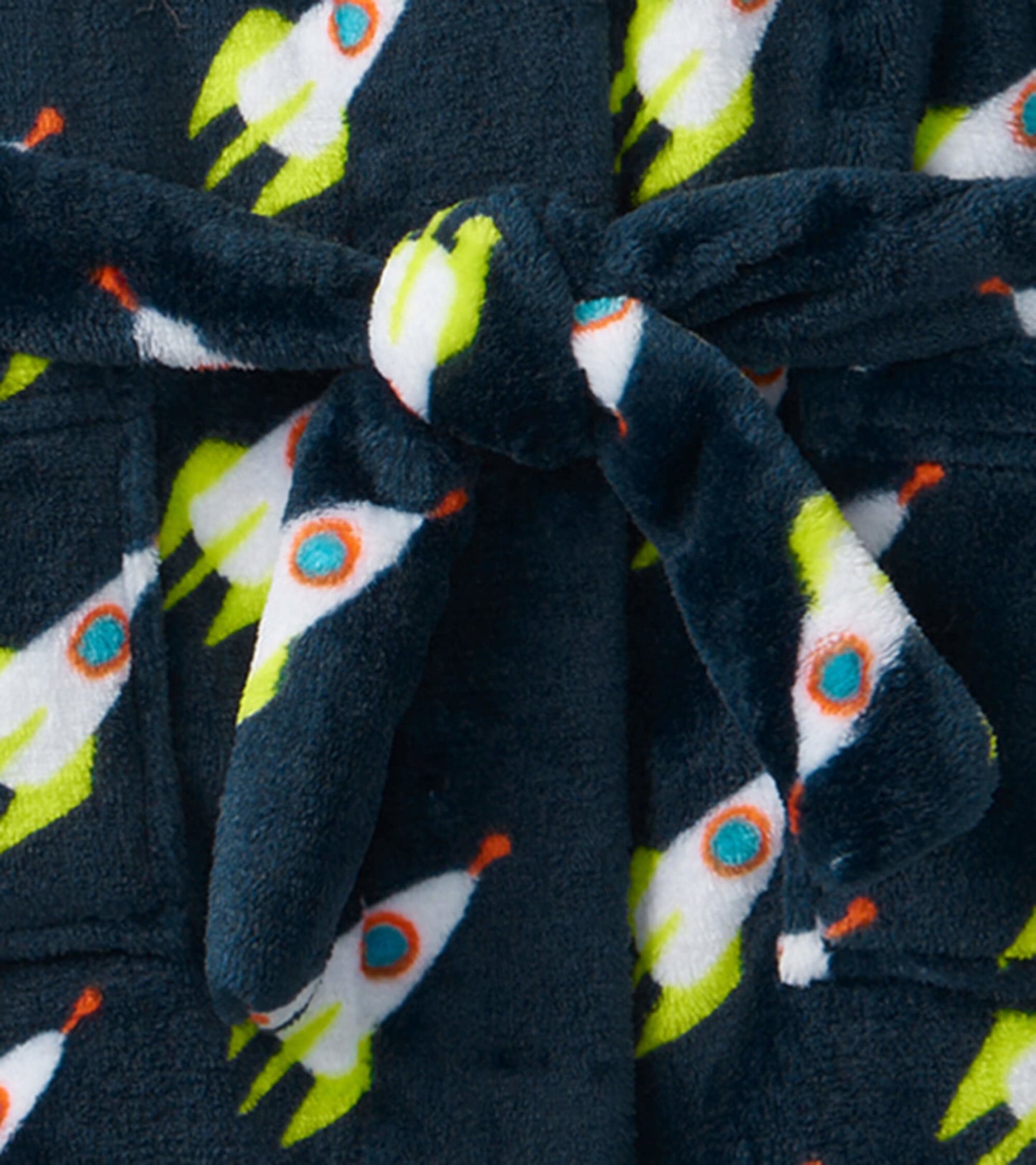 Navy fleece robe featuring colorful rocket patterns, tied at the waist with a matching belt.