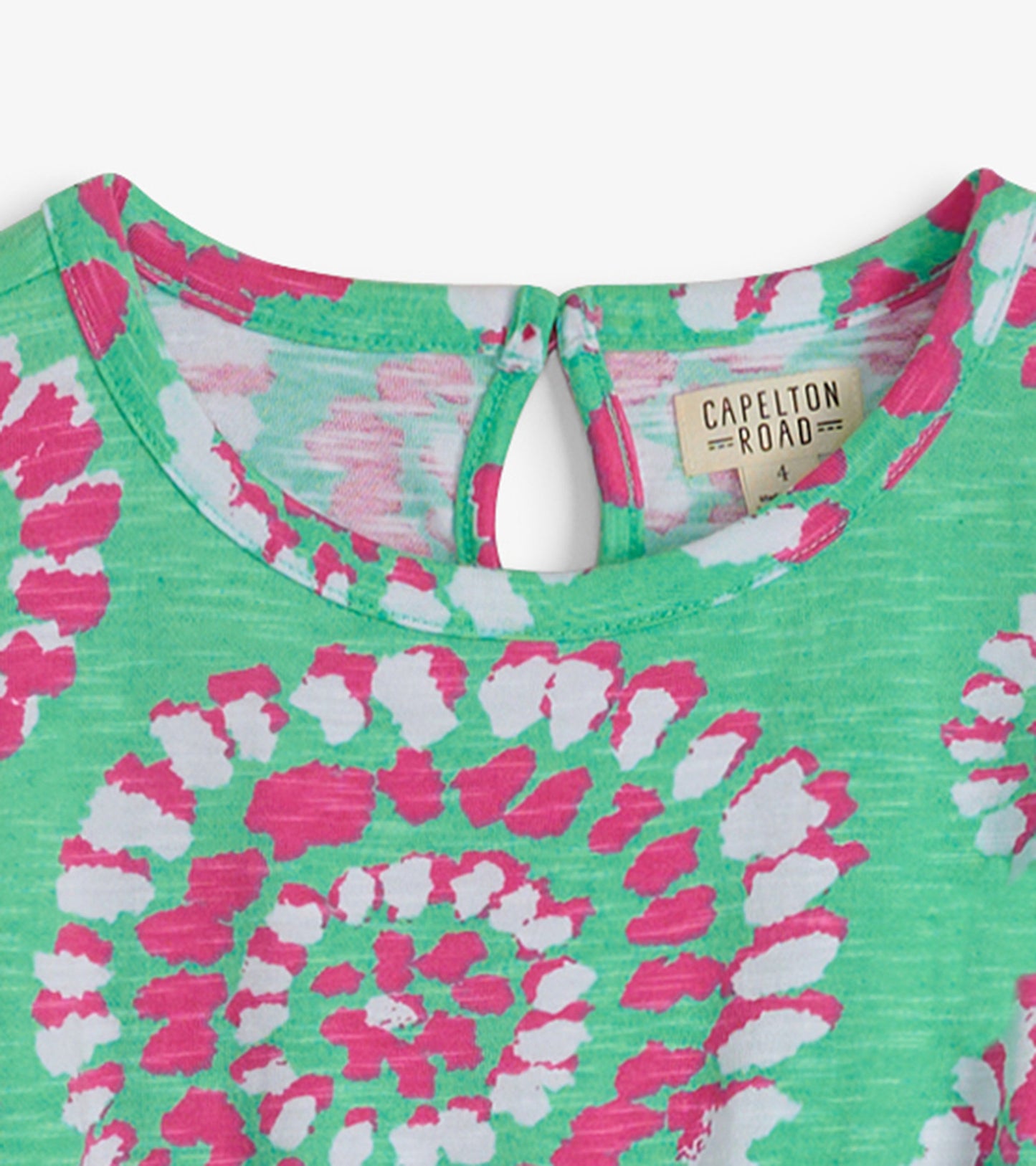 Green t-shirt dress featuring a vibrant pink and white mandala pattern, with a keyhole back detail.